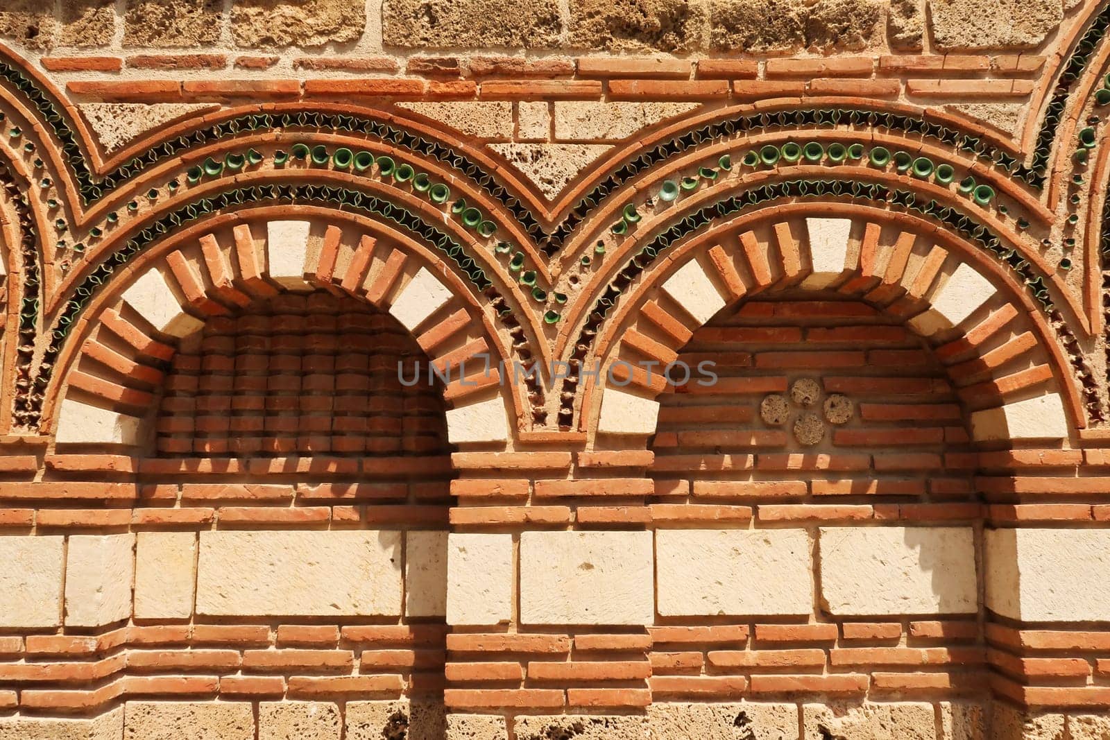 Patterns out of bricks and tiles decorate the elaborate facade of the Church of St., Saint Paraskevi, Sveta Paraskeva in the old town of Nessebar, Nesebar, Bulgaria 2022