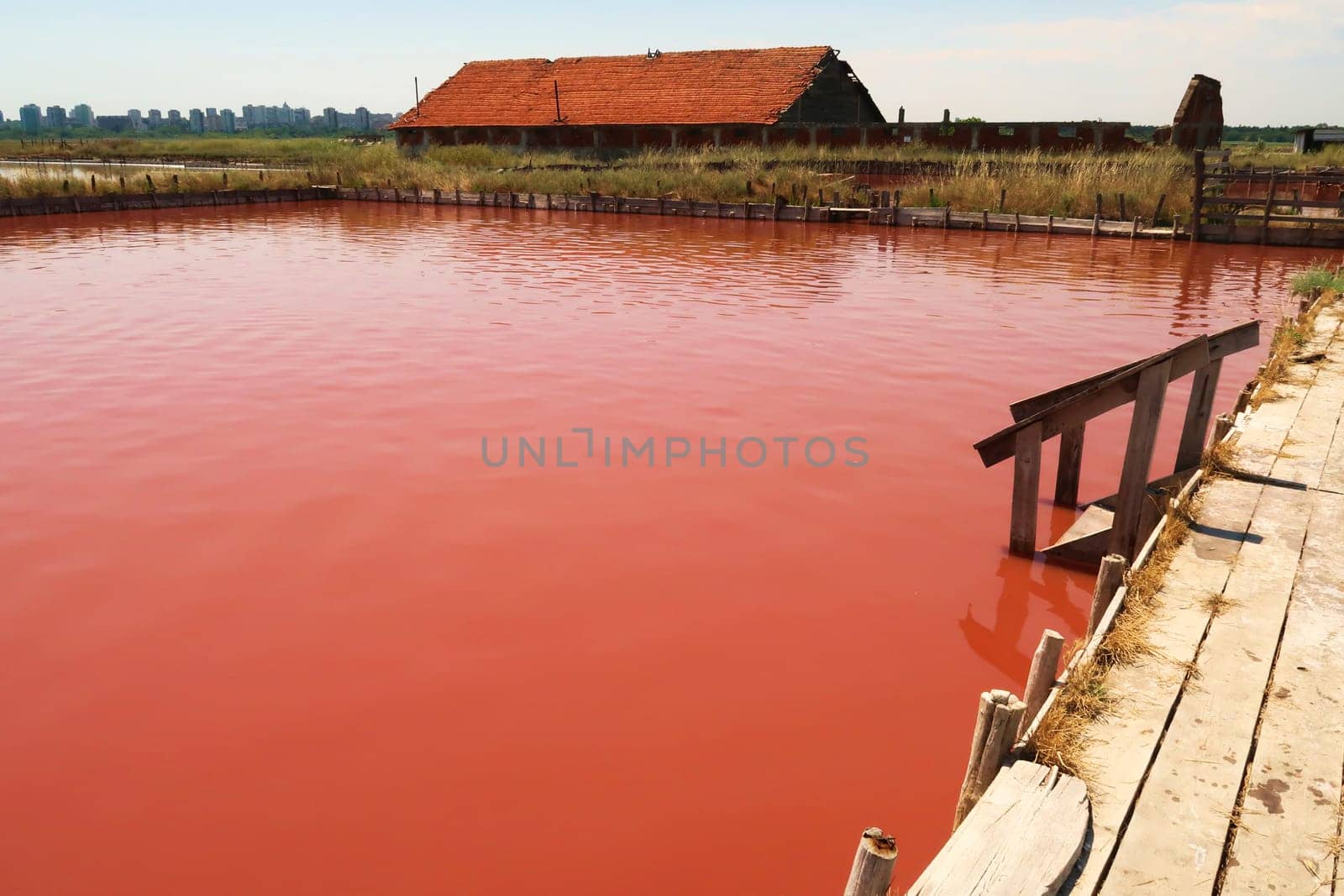 Board walk and stairs leading into the main bathing, swimming pool with its intense pink color at the Burgas Salt Pans, Lake Atanasovsko, Atanasovo, Burgas, Bourgas, Bulgaria 2022