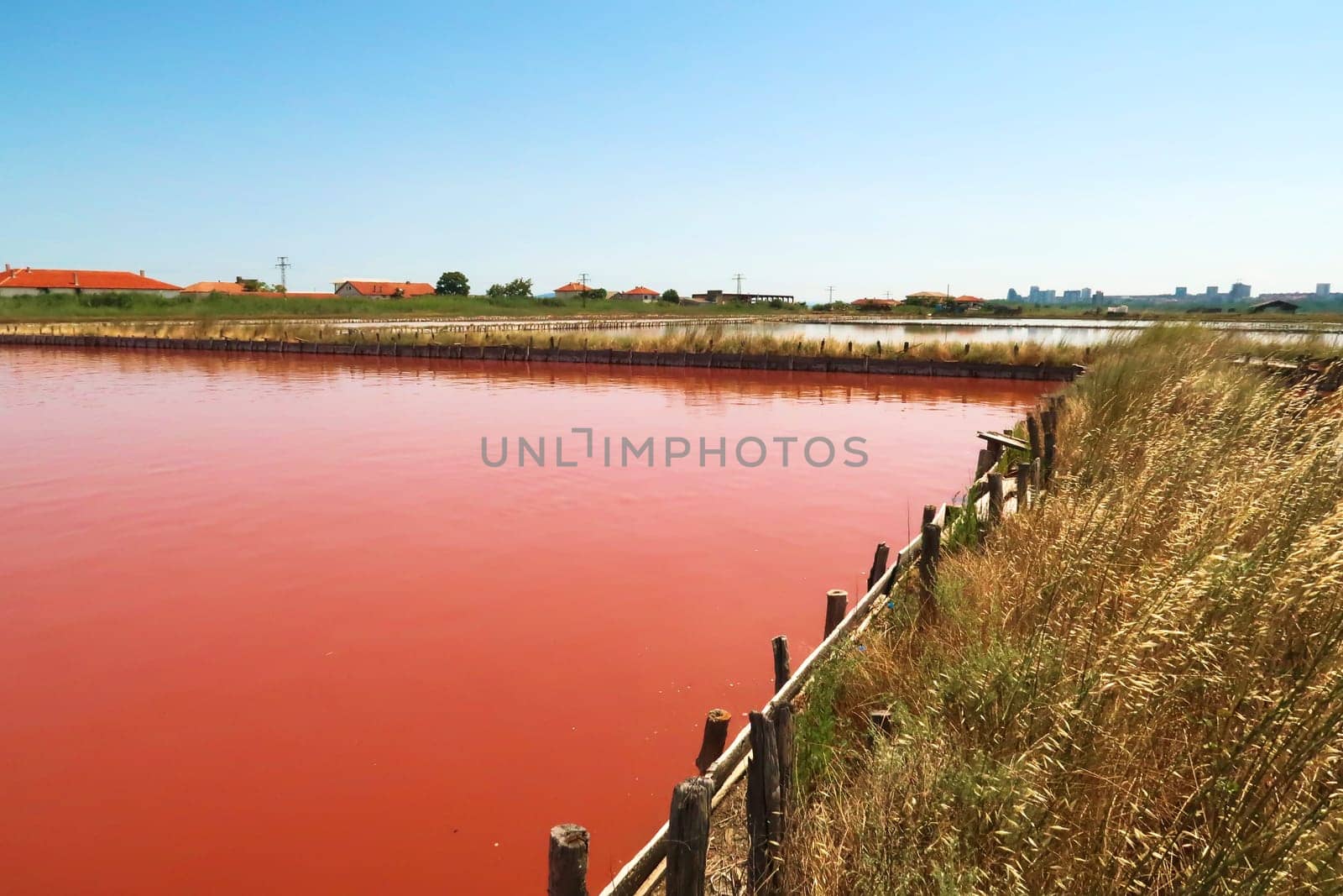 View onto the main bathing, swimming pool at the Burgas Salt Pans, water of intense pink color, Lake Atanasovsko, Atanasovo, Burgas, Bourgas, Bulgaria 2022