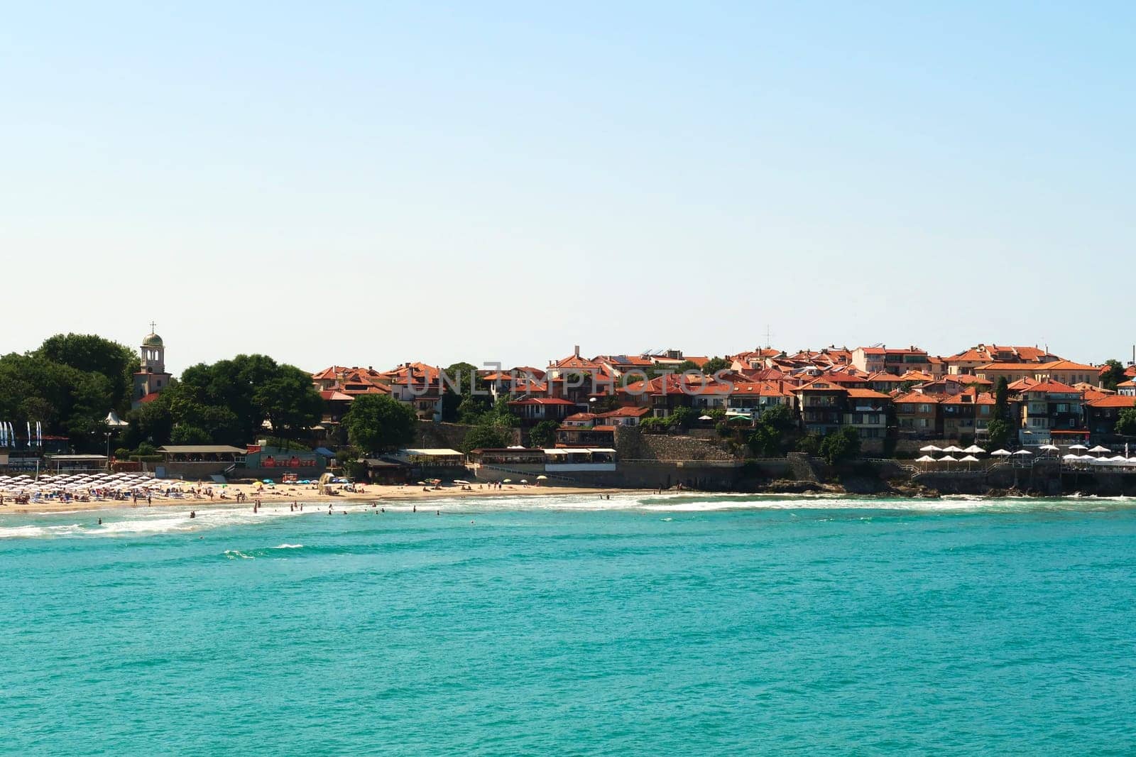 The old town of Sozopol, Sosopol next to the Sozopol Central Beach, intense blue turquoise water in the foreground, Bulgaria 2022