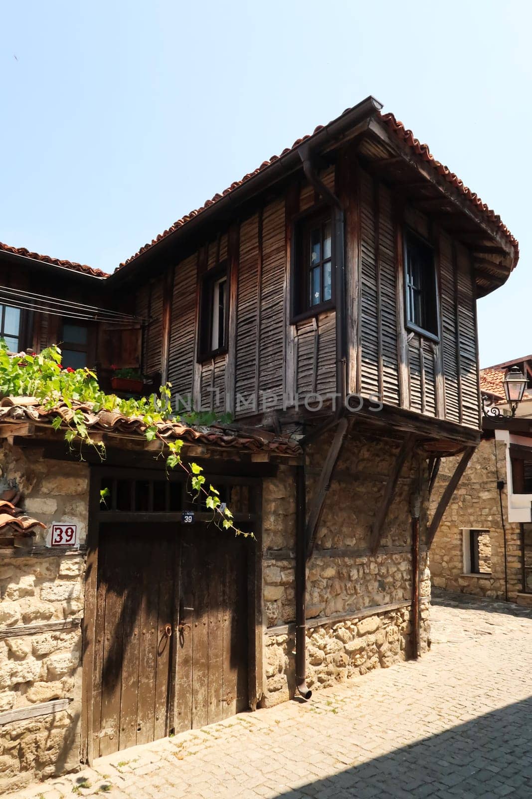 A traditional wooden house in a cobble stone street in the old town of Nessebar, Nesebar, Bulgaria 2022