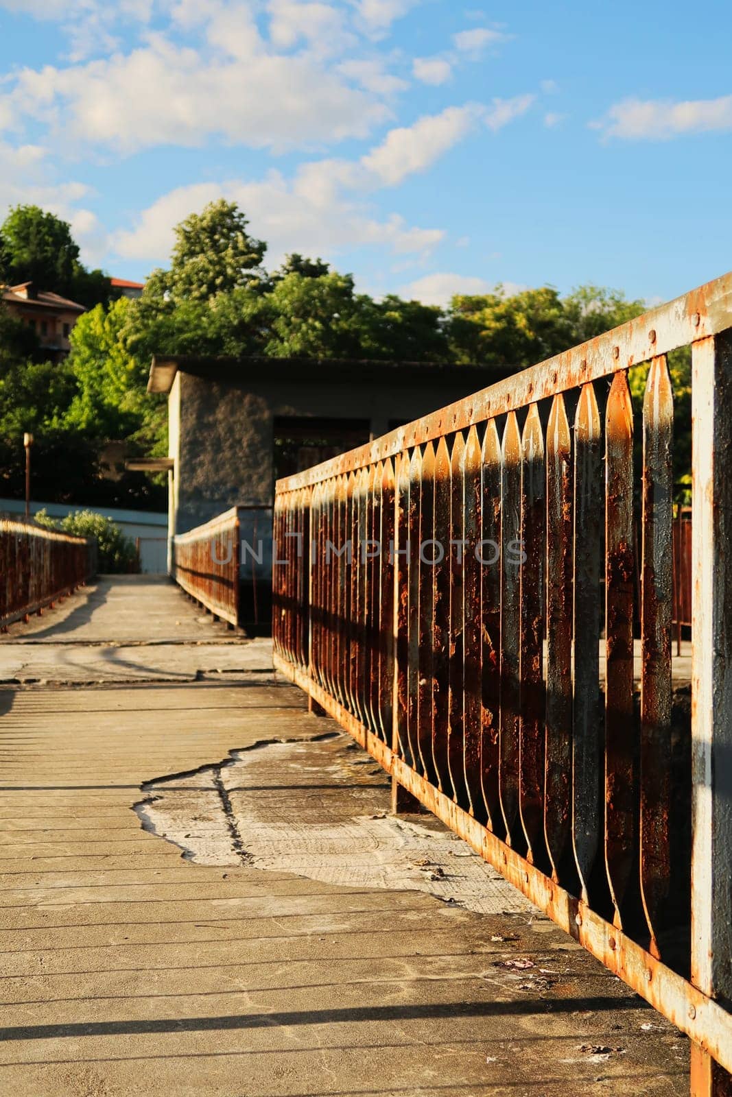 Rusted, rusty railing, handrail, rail on old concrete with potholes at an abandoned dam on the Yantra River in Veliko Tarnovo, Bulgaria 2022