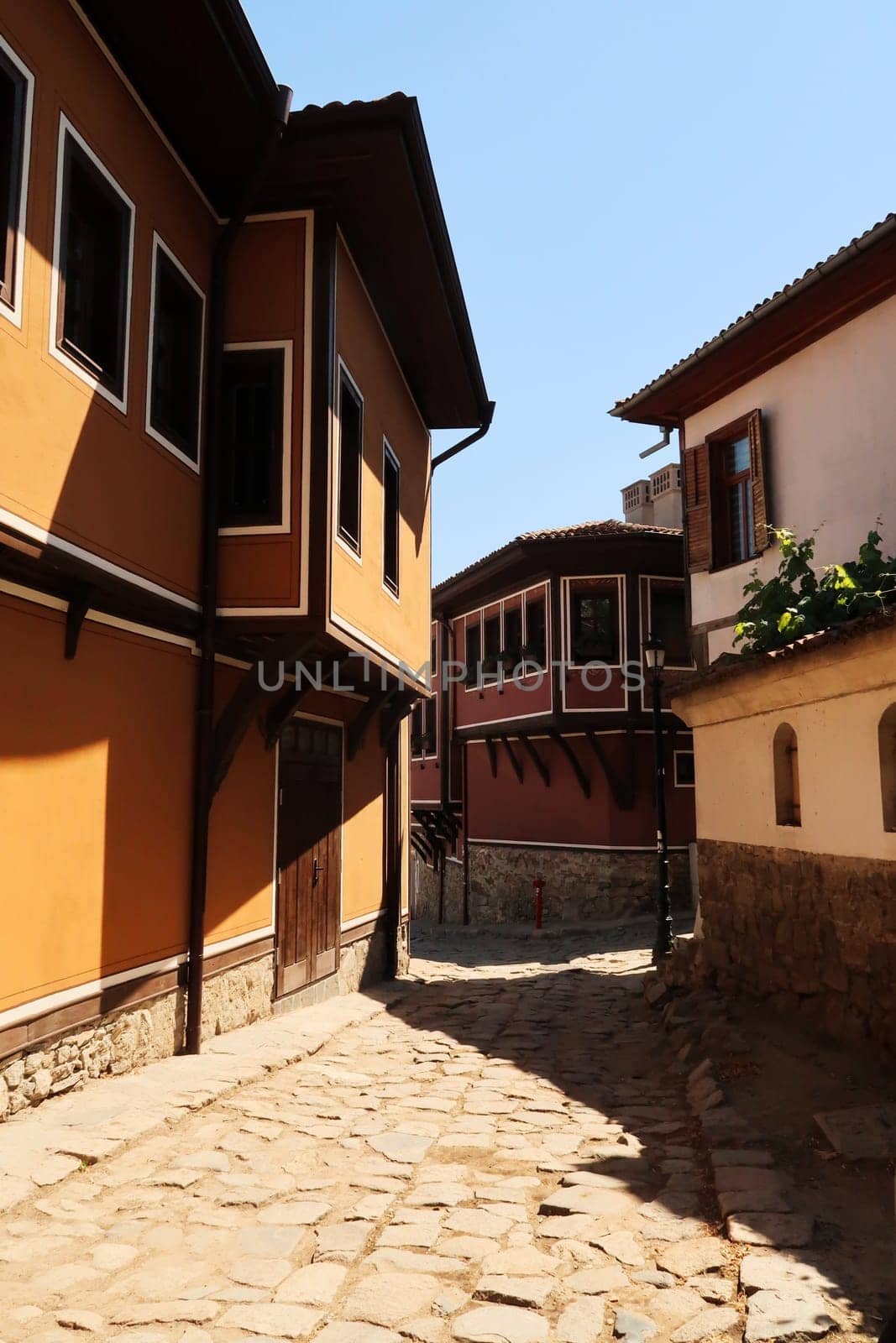 Beautiful cobble stone street between traditional houses in the old town of Plovdiv, Plowdiw, Bulgaria 2022