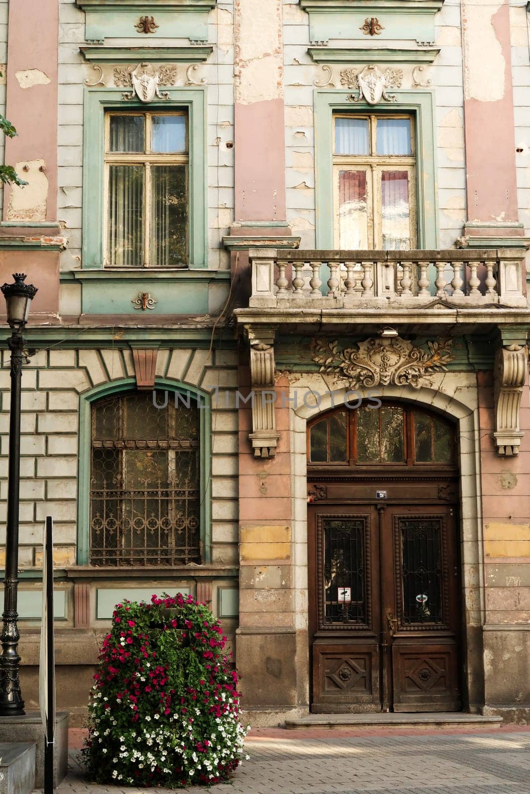 The wooden entrance door and the lower facade of the former Bulgarian National Bank building in the old town of Plovdiv, Plowdiw, Bulgaria 2022