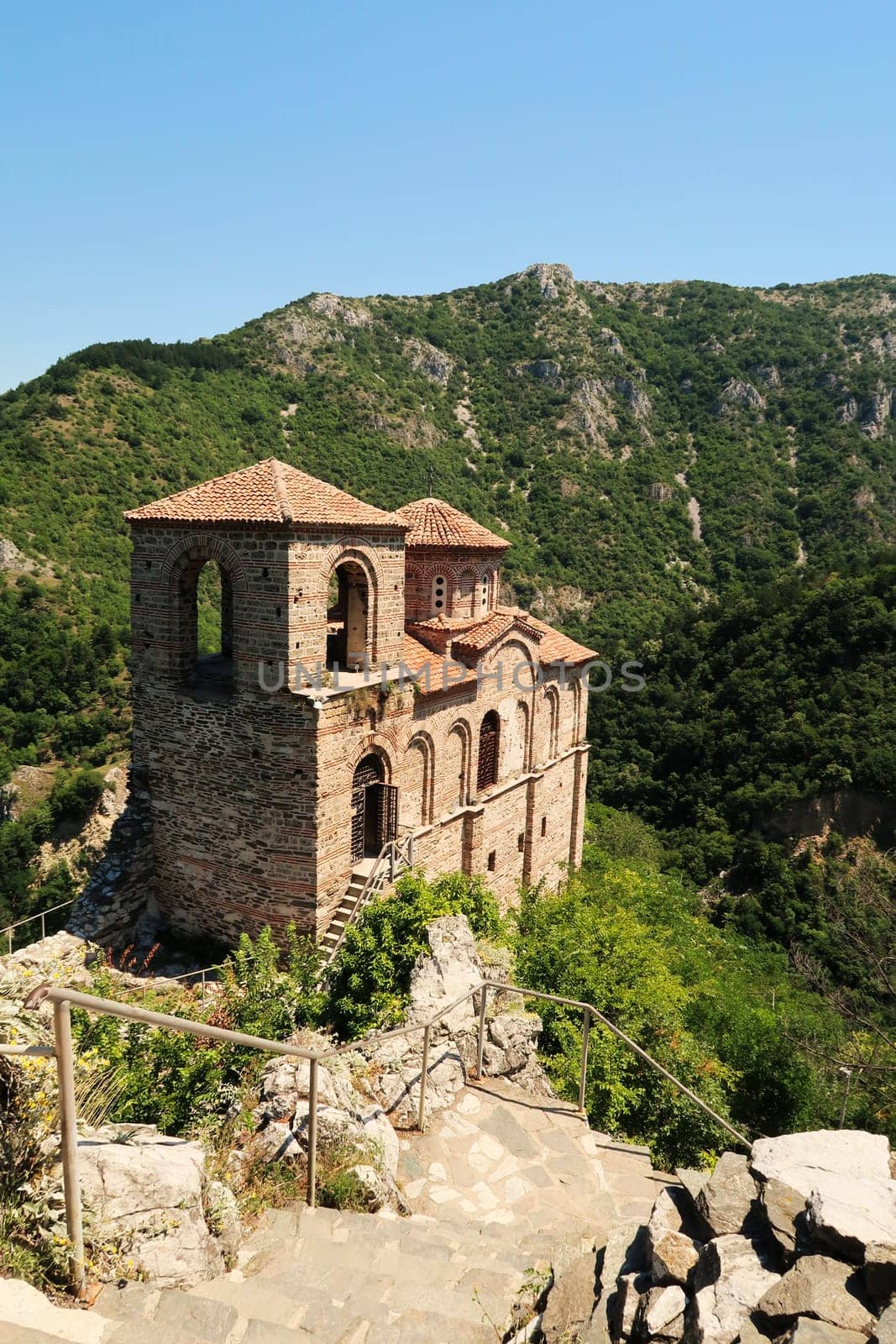Stairs leading down to the Church of the Holy Mother, part of the medieval Asen's, Asens Fortress, surrounded by mountains and dense, lush vegetation, forest, near Plovdiv, Bulgaria 2022
