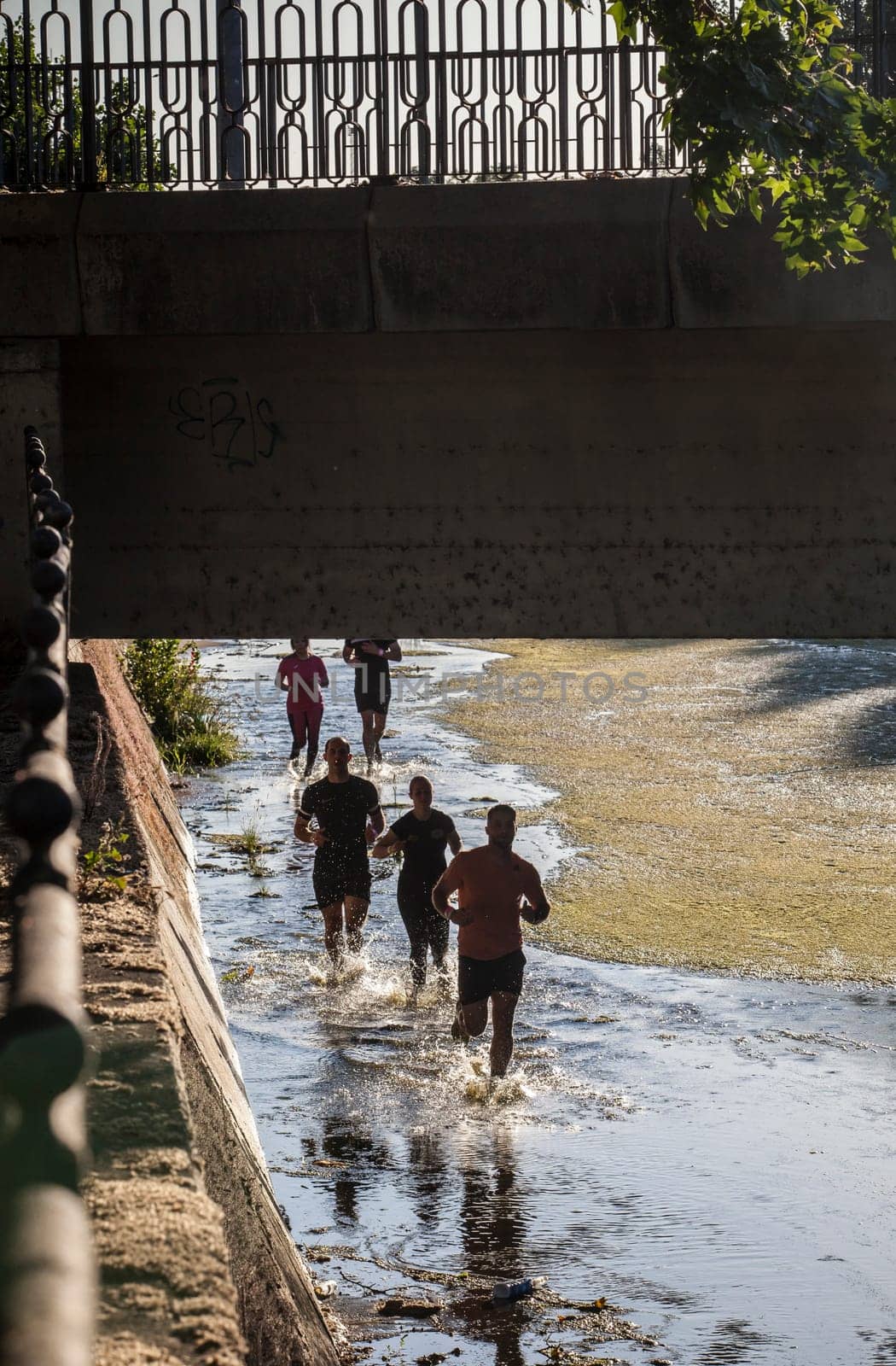 Merida, Spain - May 18th, 2024: FarinatoRace Merida 2024, Participants running along the Albarregas river
