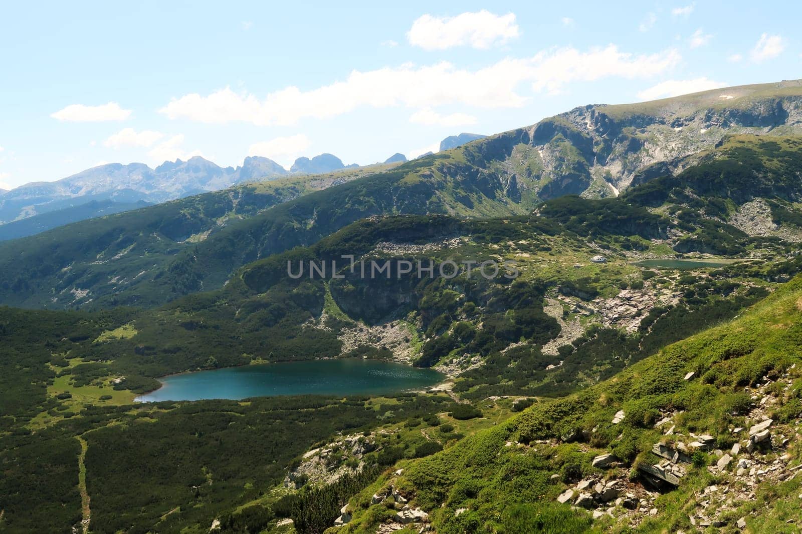 View onto the Lower Lake, Dolnoto Ezero and the Fish Lake, Ribnoto Ezero with the Seven Lakes Chalet right next to it at the Seven Rila Lakes Plateau, Rila National Park close to Sofia, Bulgaria 2022