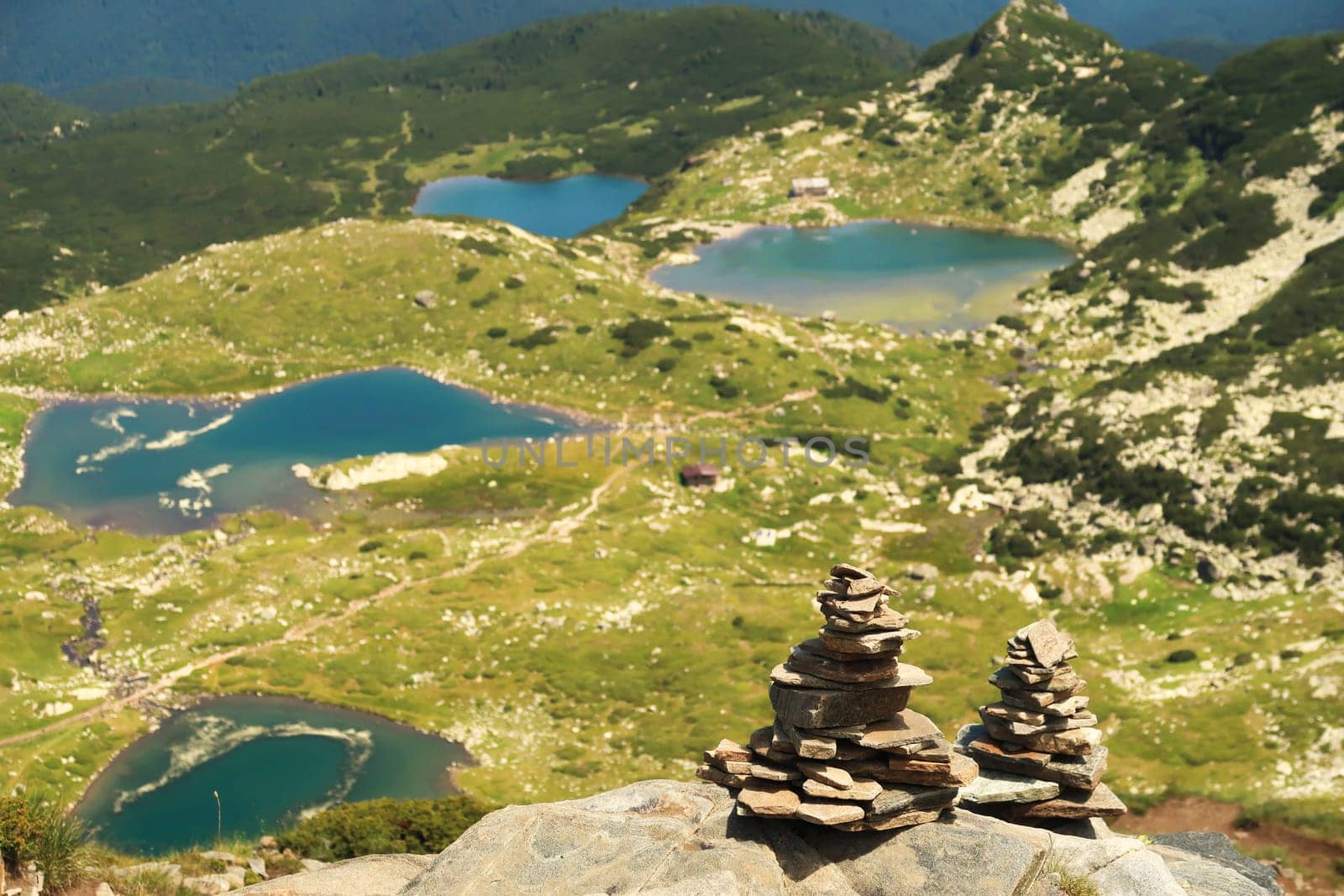 Two stacks, piles, pillars, towers of pebbles, stones at the Rila National Park, a view onto four of the Seven Rila Lakes can be seen in the background, close to Sofia, Bulgaria 2022