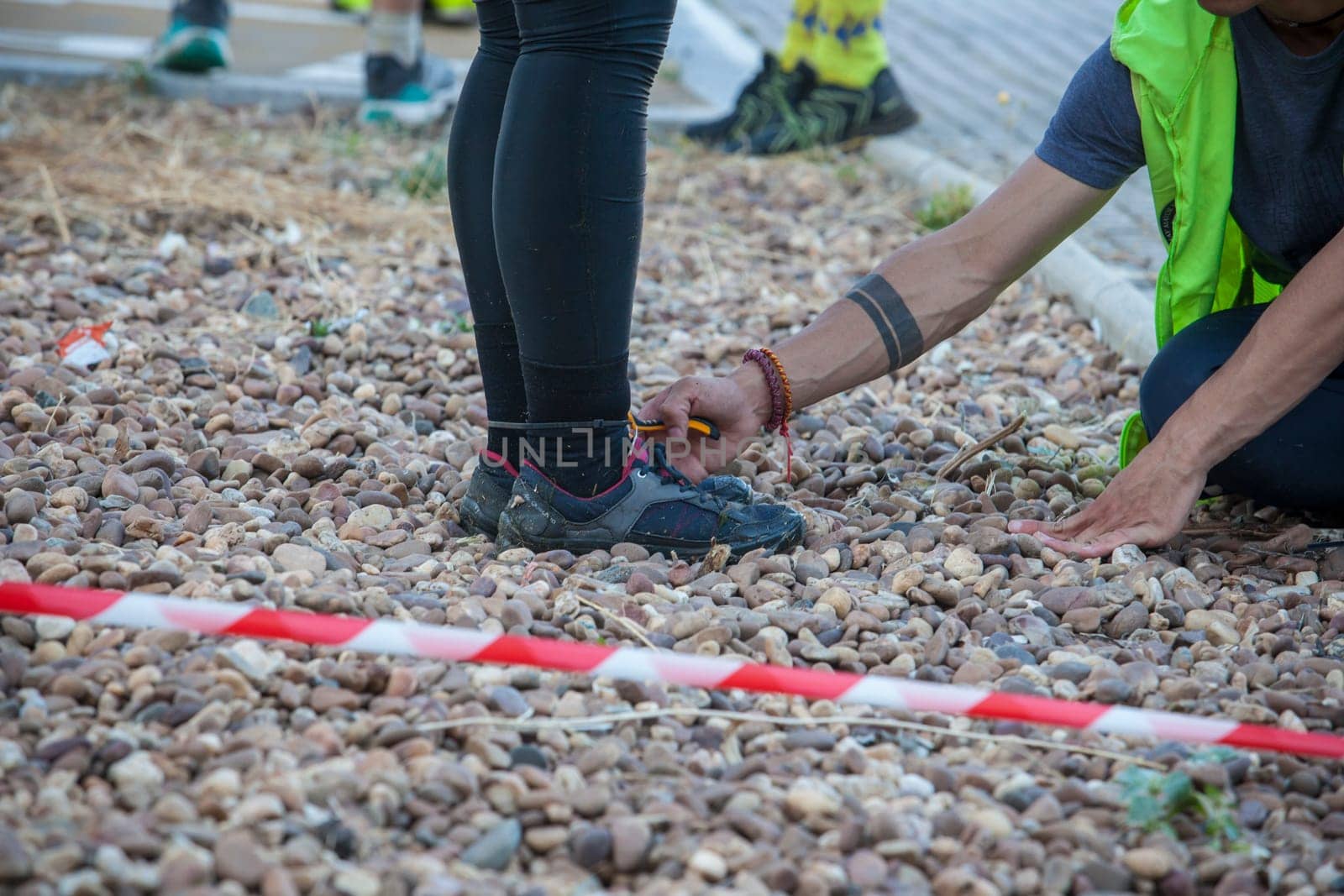 Merida, Spain - May 18th, 2024: FarinatoRace Merida 2024. Assistant cutting the bridle