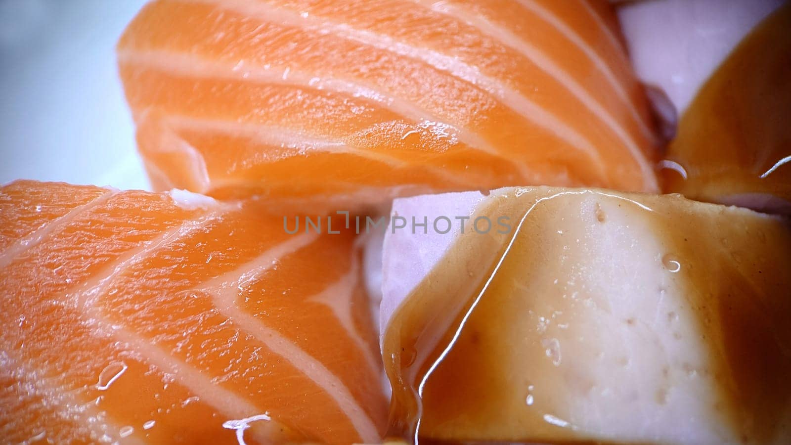Japanese food sushi rolls of red fish and ham with sweet sauce. Texture or background.View from above.Macrophotography.