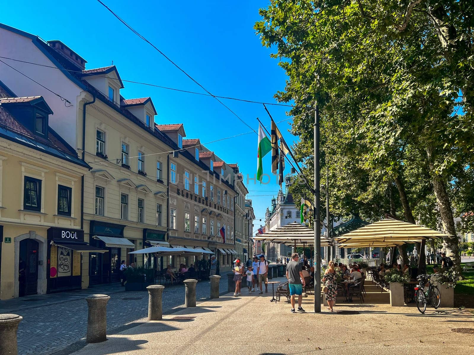 Slovenska Matica building on Kongresni Trg street, view of people in cafe gardens