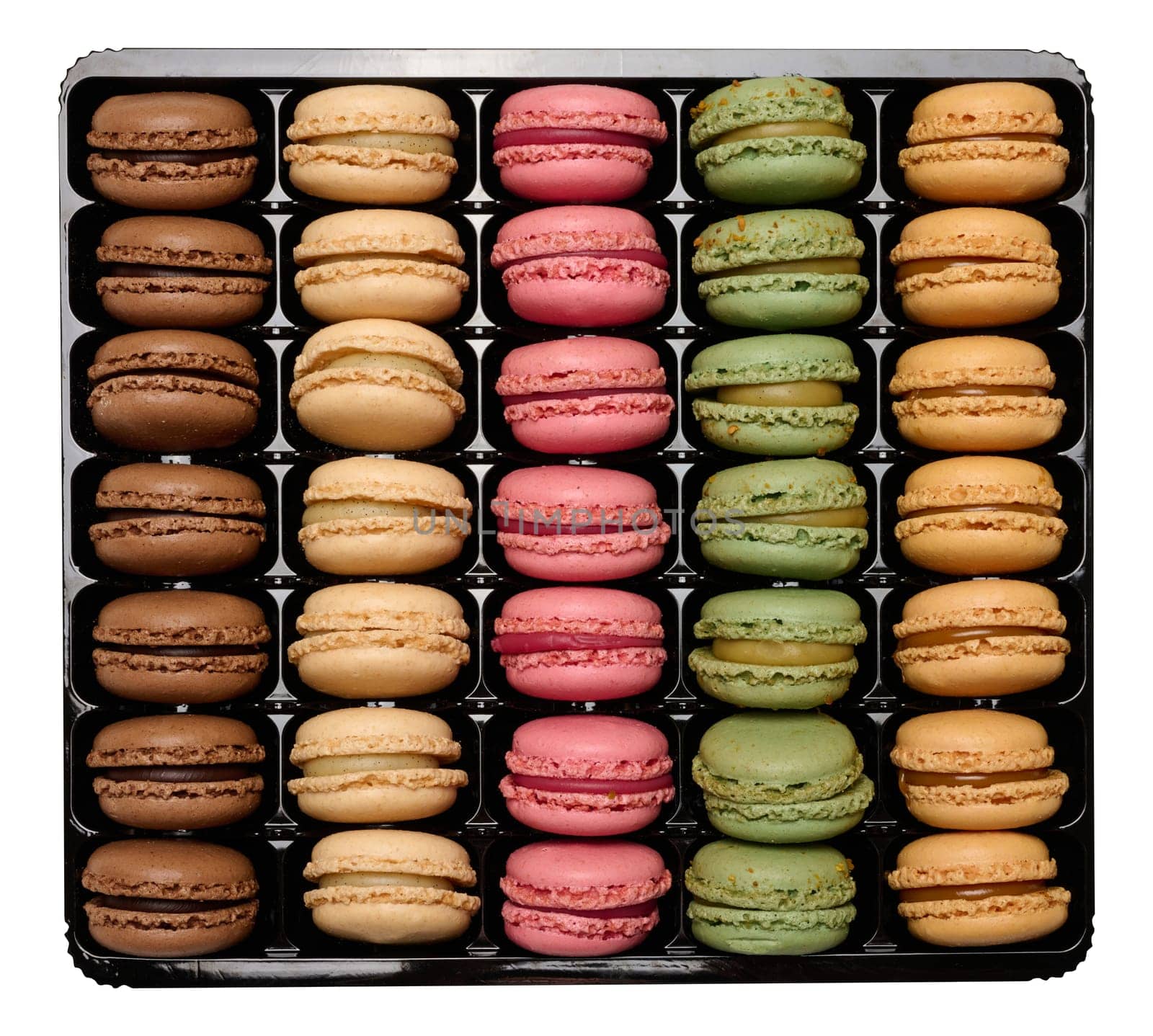 Multi-colored macarons in a plastic box, top view. Assortment. Isolated background