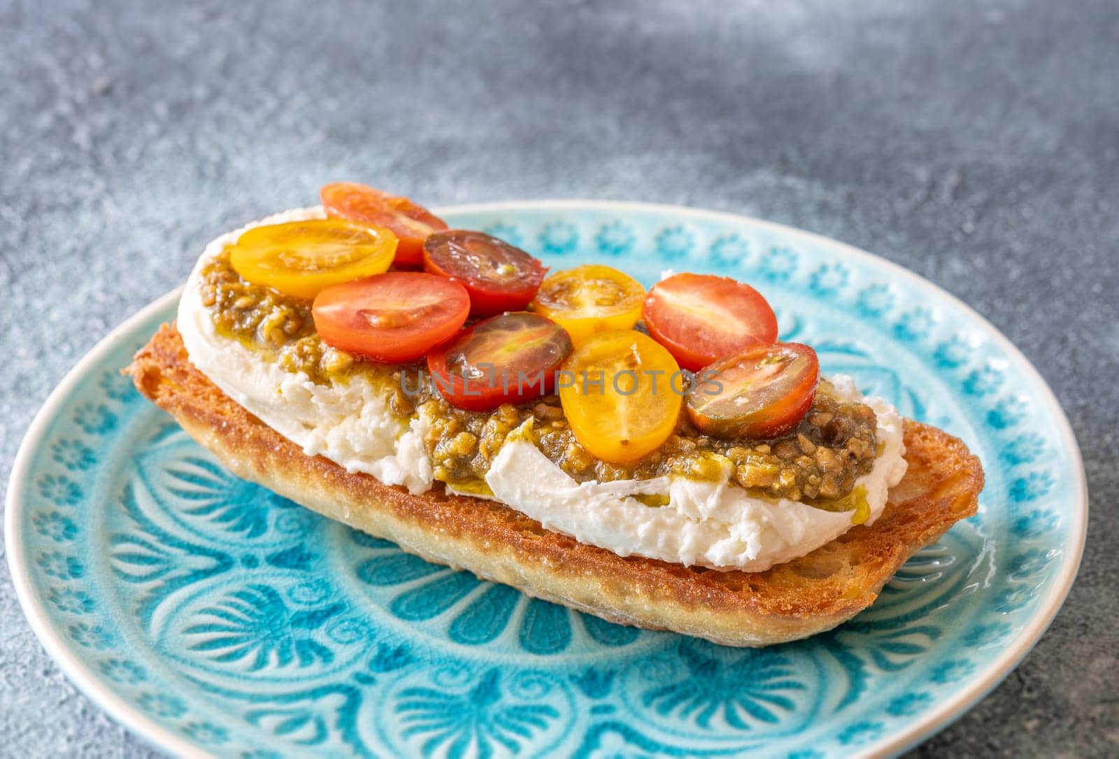 Bruschetta with burrata cheese, pesto and tomatoes