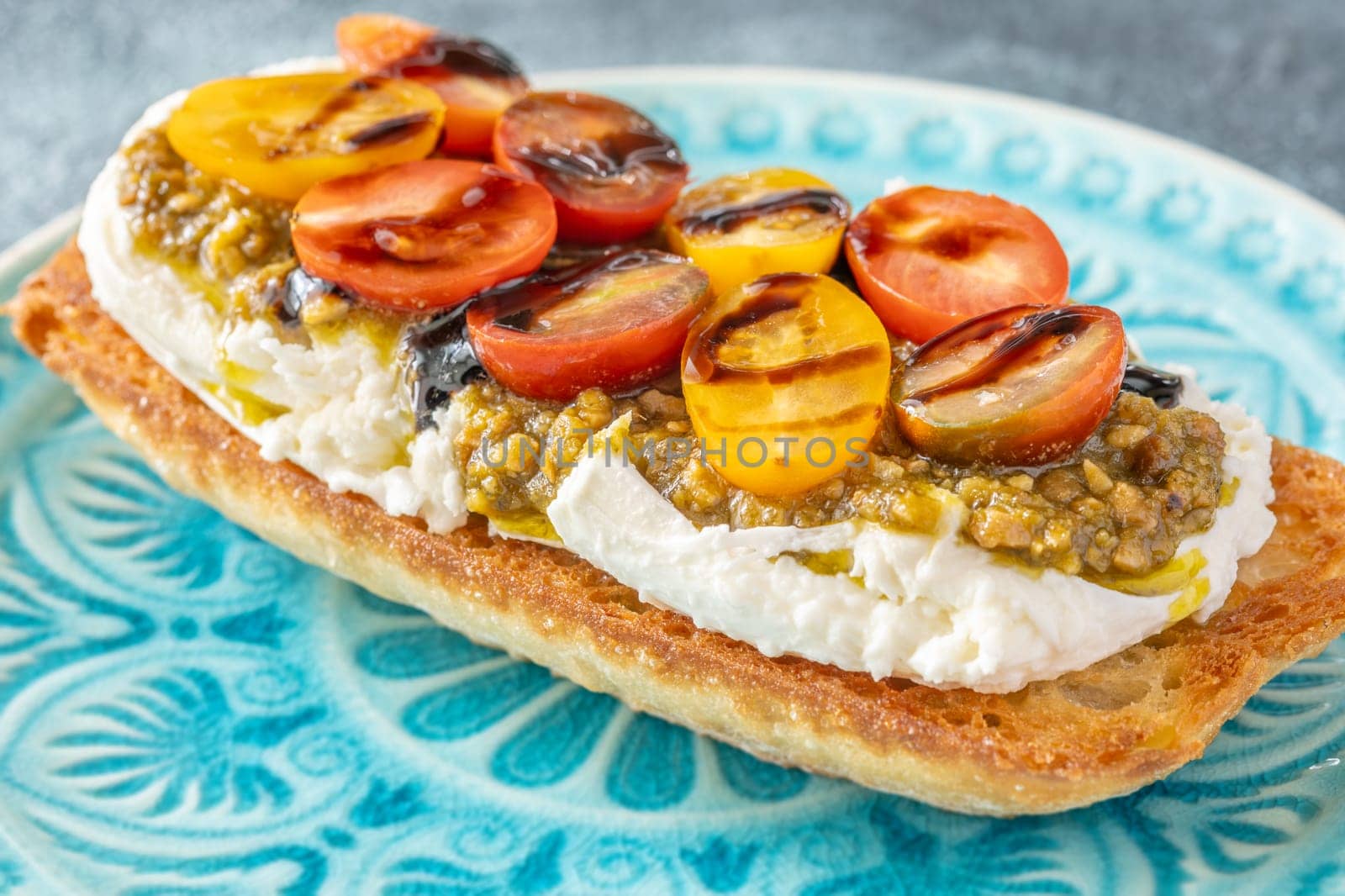 Bruschetta with burrata cheese, pesto and tomatoes