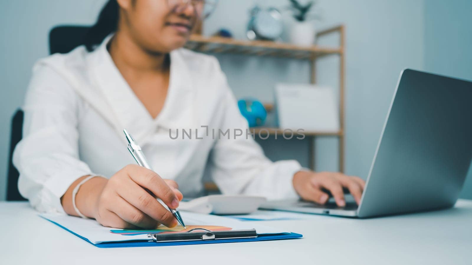 Business woman people use computers and paper documents to analyze business and manage corporate information. Business analysis with charts, indicators, and KPIs to improve organizational performance.