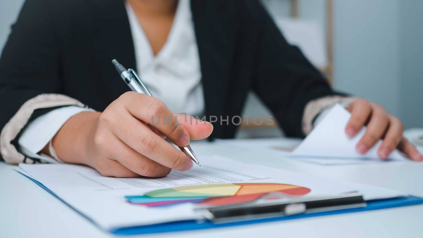 Business woman people use computers and paper documents to analyze business and manage corporate information. Business analysis with charts, indicators, and KPIs to improve organizational performance.