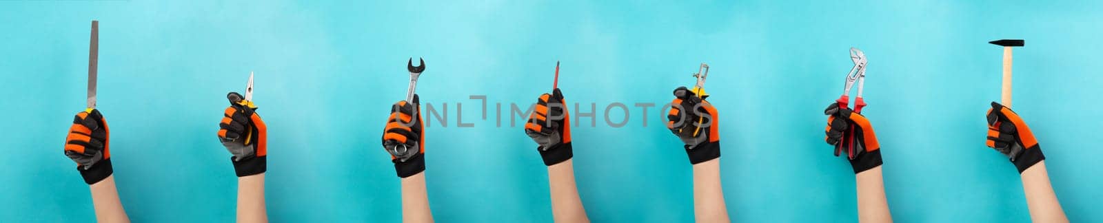 Craftsman or handyman with different tools in the hand, labor day, craft and apprentice, hammer, pliers and wrech