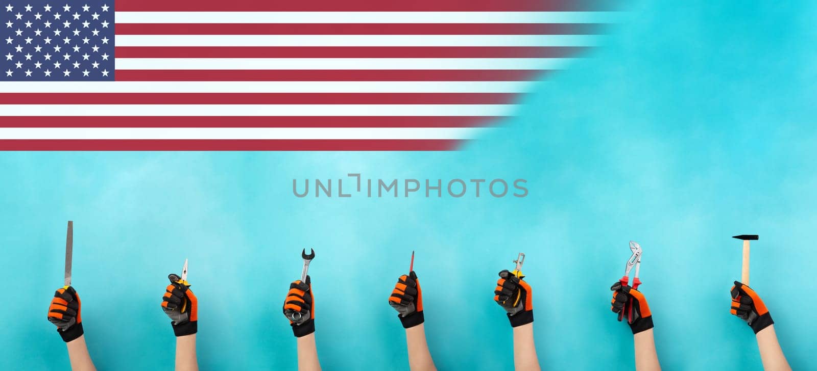 Craftsman or handyman with different tools in the hand, labor day, american flag, craft and apprentice, hammer, pliers and wrech