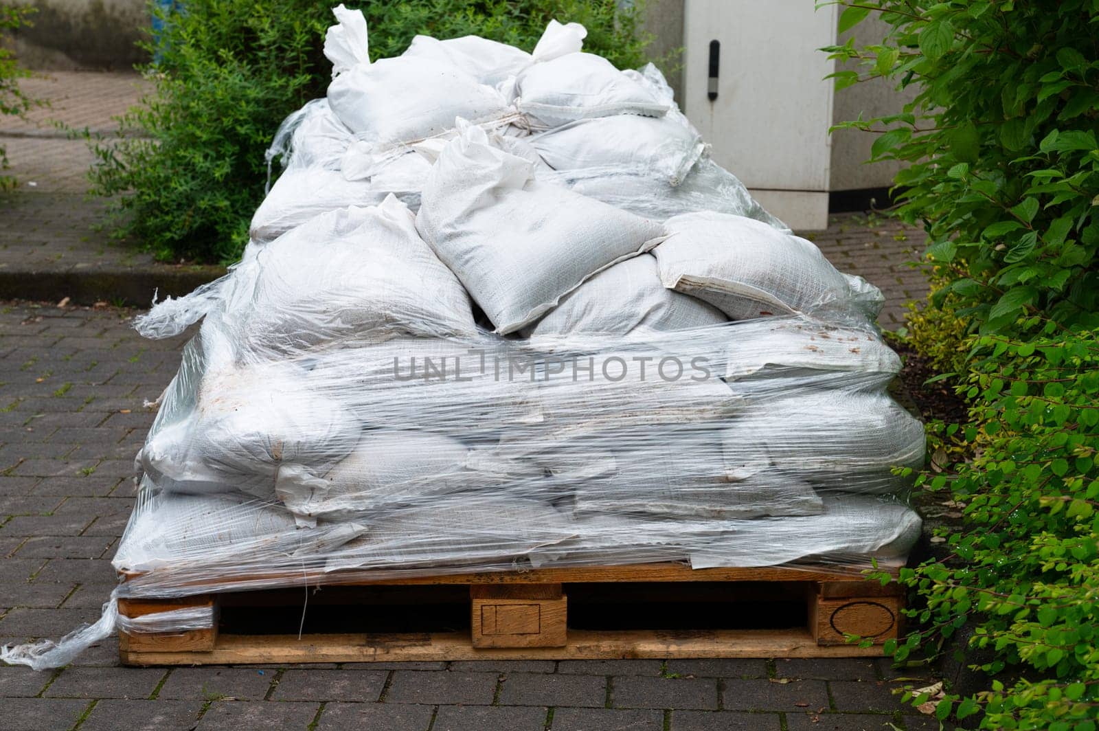 Sandbags for flood defense, river Moselle Trier in Rhineland Palatinate, flooded trees and paths, high water level, climate change