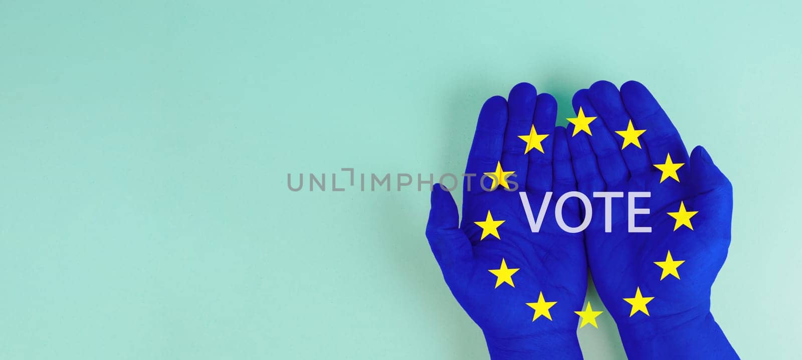 EU election, hand with european union flag, blue and yellow stars, citizens of Europe voting Parliament