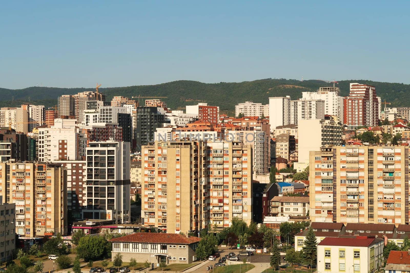 View from the bell, clock tower of the Cathedral of Saint, St. Mother Theresa onto socialist, brutalist concrete panel, multi-story, high-rise, apartment blocks, buildings in the city center of Prishtina, Pristina, Kosovo 2022