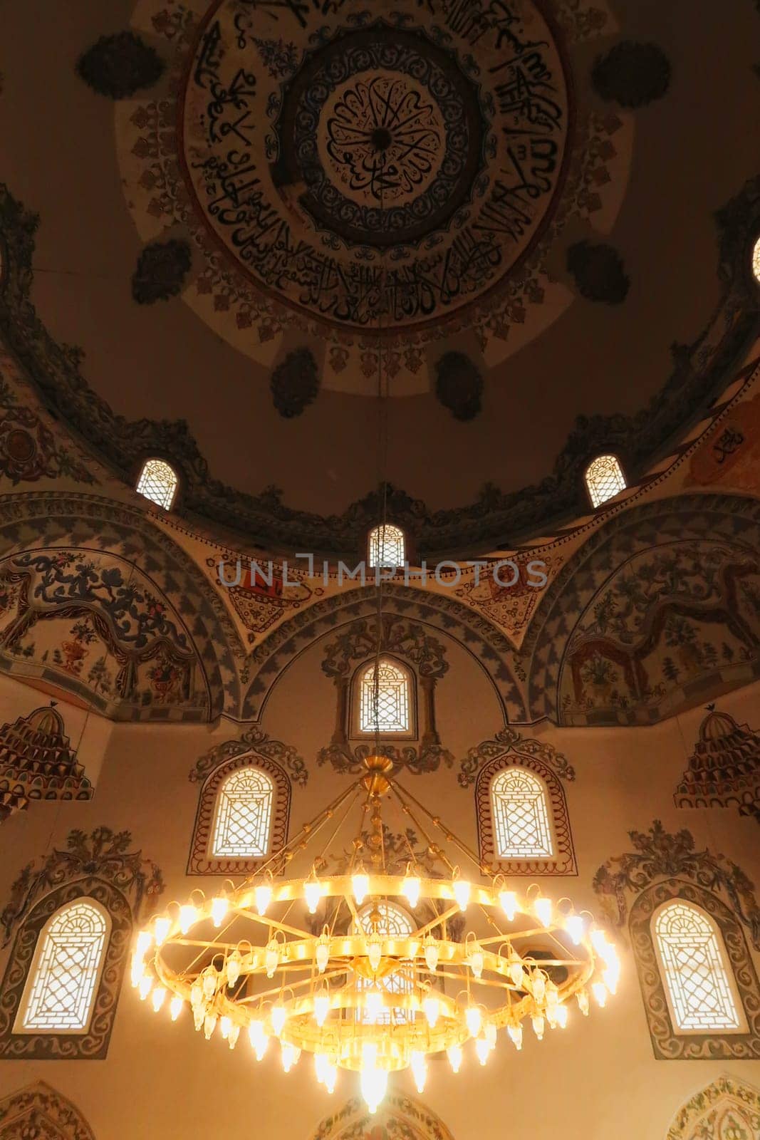 Chandelier and elaborate ceiling decoration, pattern, painting, fresco inside the Sinan Pasha Mosque, an ottoman mosque in the old town of Prizren, Kosovo 2022