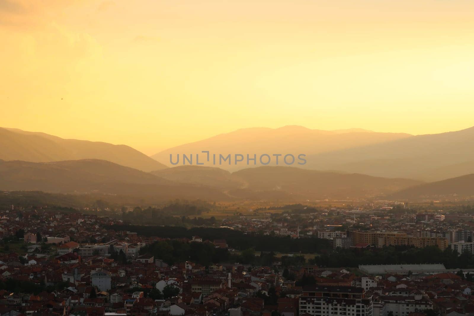 View from the Prizren Fortress onto the city and its surrounding landscape at sunset, the highway road can be seen in the far distance, Prizren, Kosovo 2022