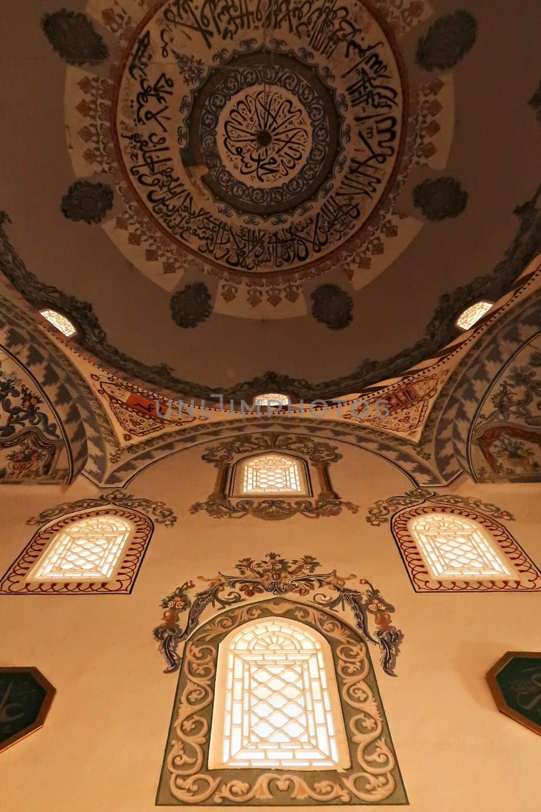 Elaborate painting, fresco, decoration, pattern, ornament on the ceiling, wall and around the windows inside the ottoman Sinan Pasha Mosque in the old town of Prizren, Kosovo 2022