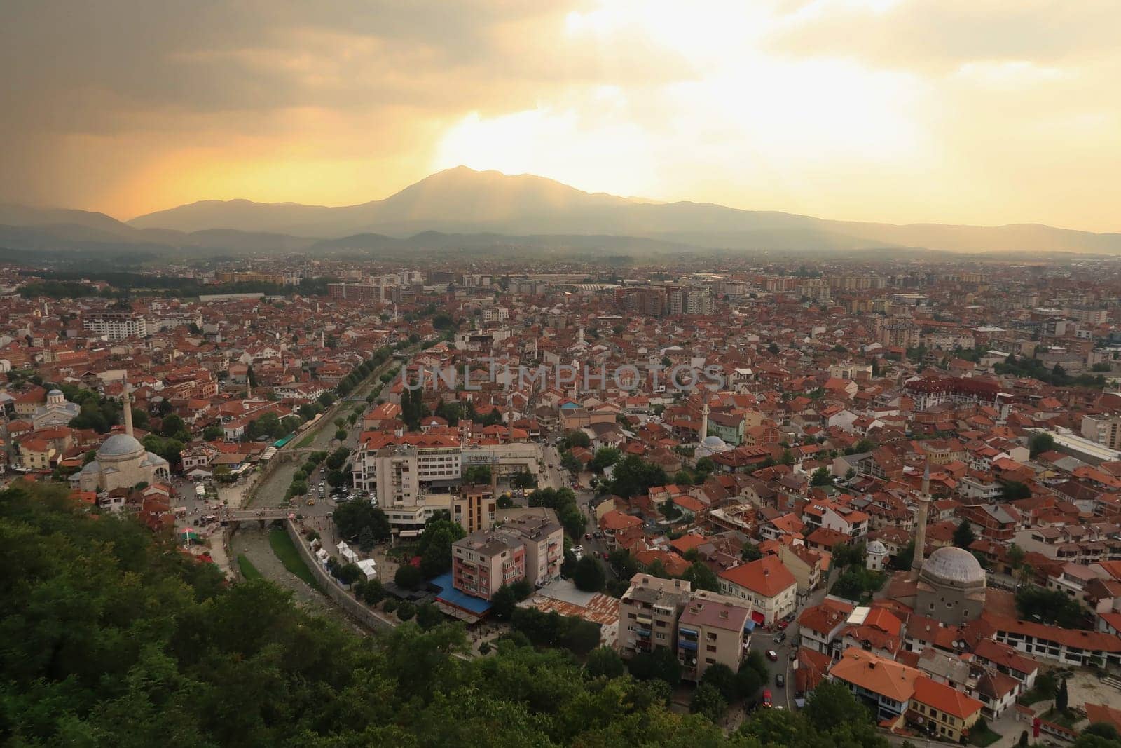 View from the Prizren Fortress onto the old town of Prizren before sunset, golden light is shining through the clouds, Prizren, Kosovo 2022