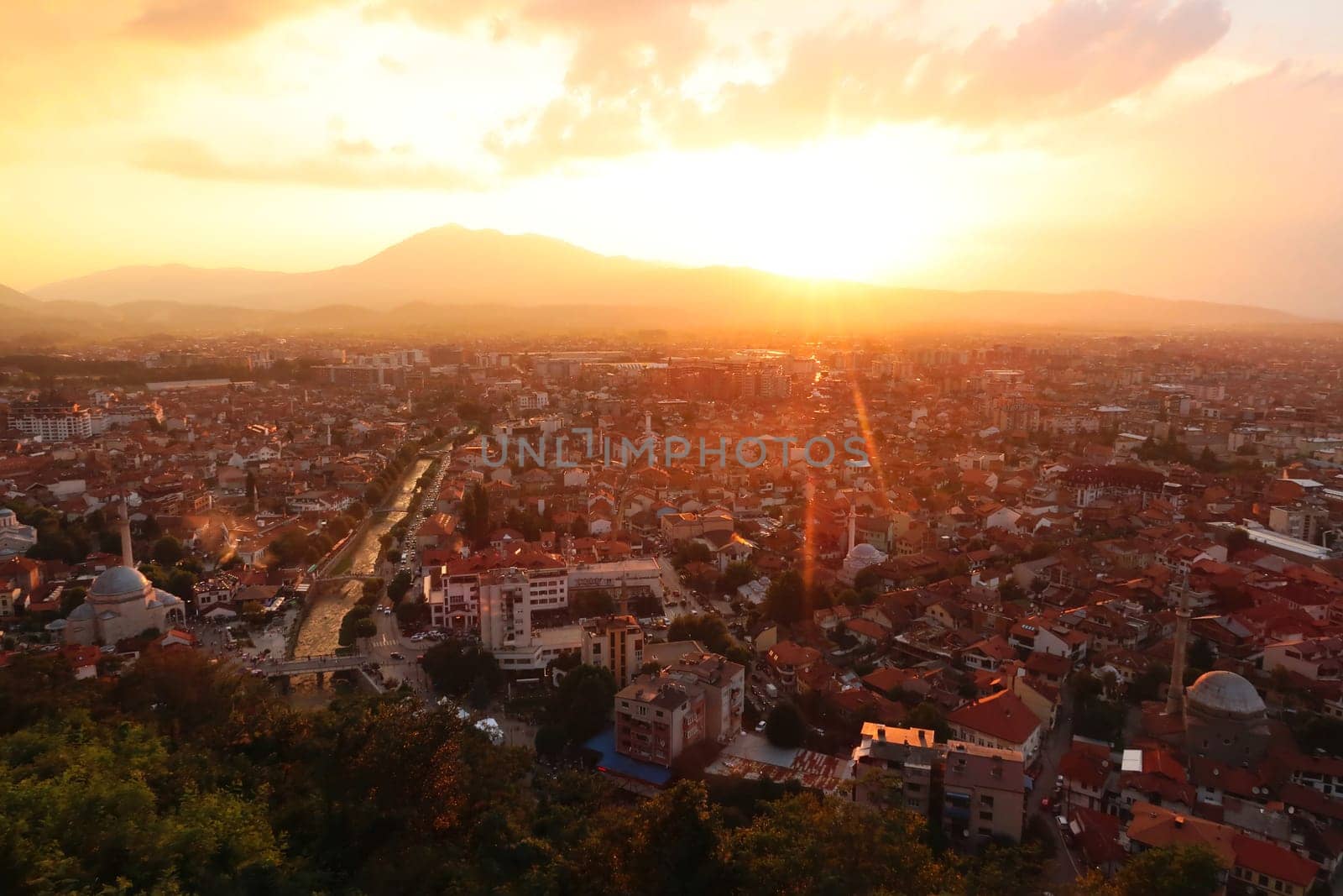 View from the Prizren Fortress onto the old town of Prizren, covered by golden sunlight during sunset, Prizren, Kosovo 2022