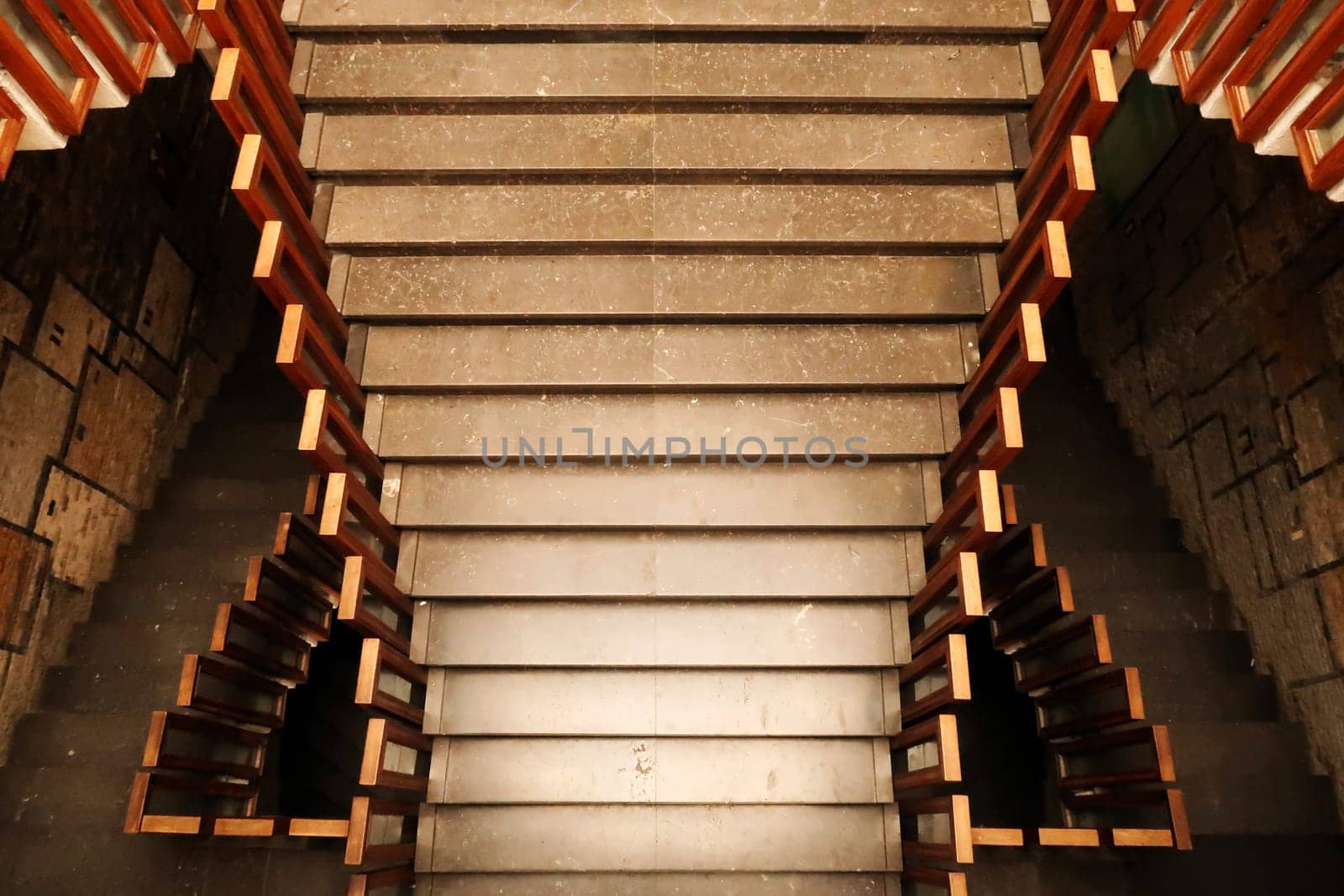Looking down onto the stairs, staircase, hallway with wooden rails, handrails, railings inside the National University Library of Kosovo, Prishtina, Pristina, Kosovo, 25th of July 2022