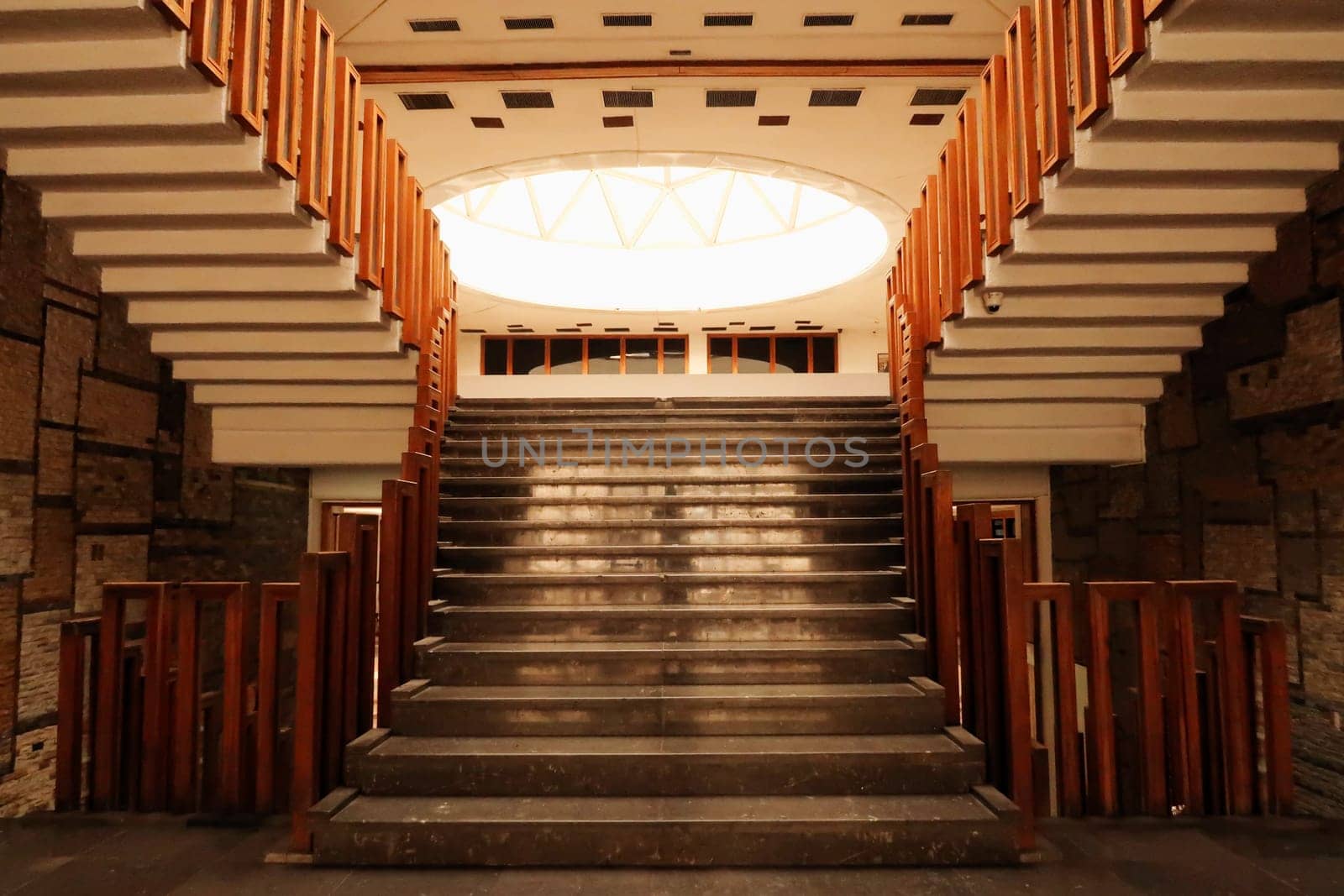 The stairs, staircase, hallway with wooden rails, handrails, railings inside the National University Library of Kosovo, Prishtina, Pristina, Kosovo, 25th of July 2022