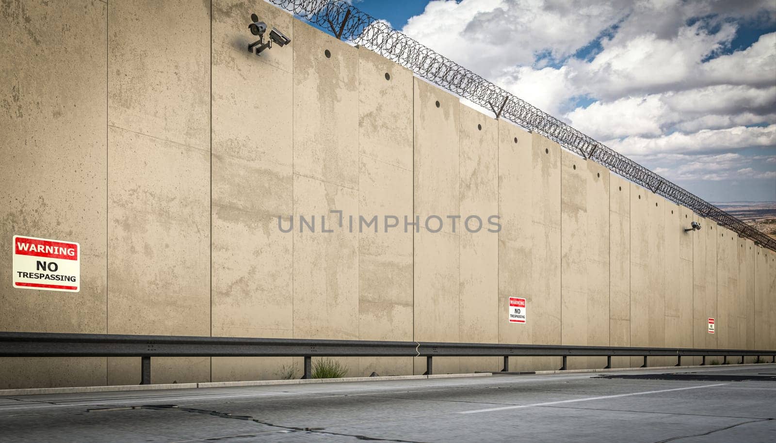 border concrete wall topped  barbed wire  no trespassing warning signs