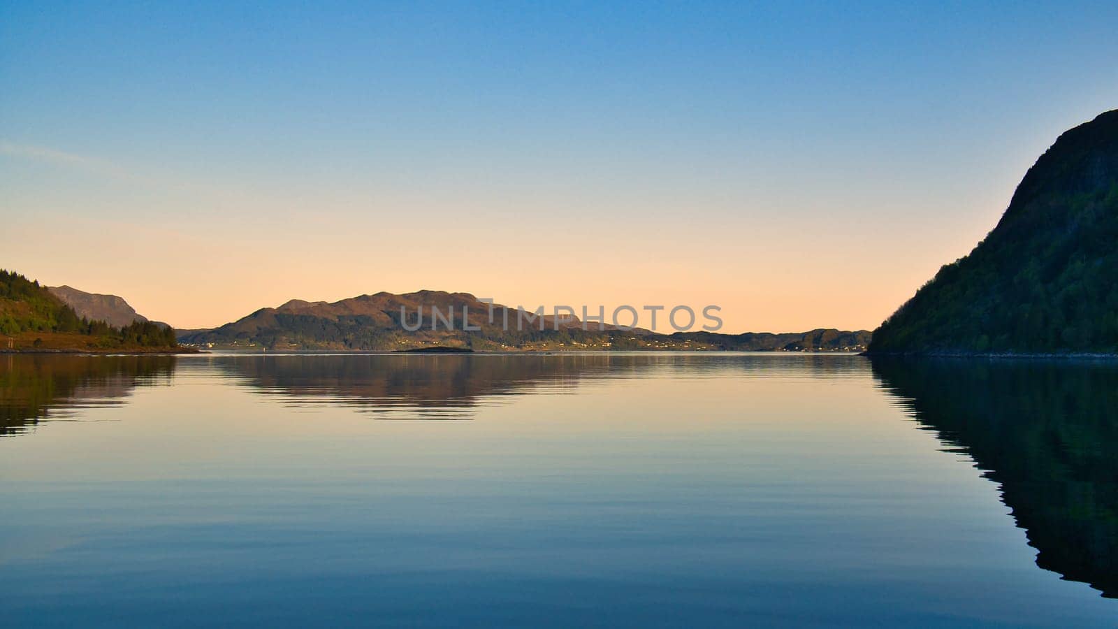 Fjord with view of mountains and fjord landscape in Norway. Landscape shot in the evening in the north at sunset