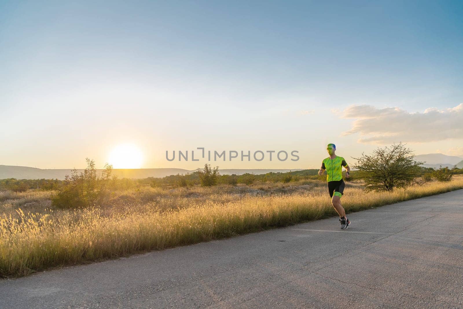 Triathlete in professional gear running early in the morning, preparing for a marathon, dedication to sport and readiness to take on the challenges of a marathon