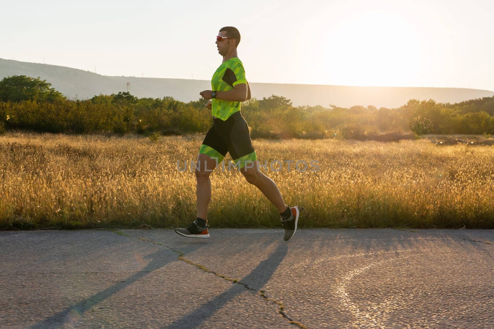 Triathlete in professional gear running early in the morning, preparing for a marathon, dedication to sport and readiness to take on the challenges of a marathon