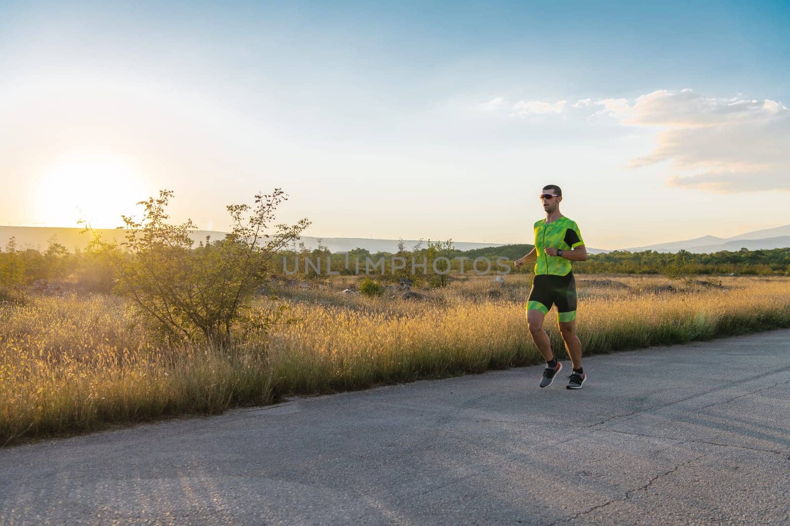 Triathlete in professional gear running early in the morning, preparing for a marathon, dedication to sport and readiness to take on the challenges of a marathon