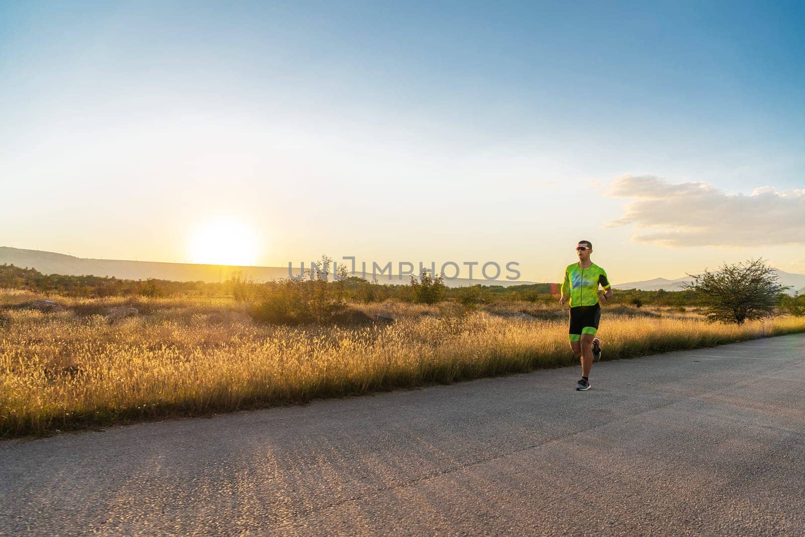 Triathlete in professional gear running early in the morning, preparing for a marathon, dedication to sport and readiness to take on the challenges of a marathon