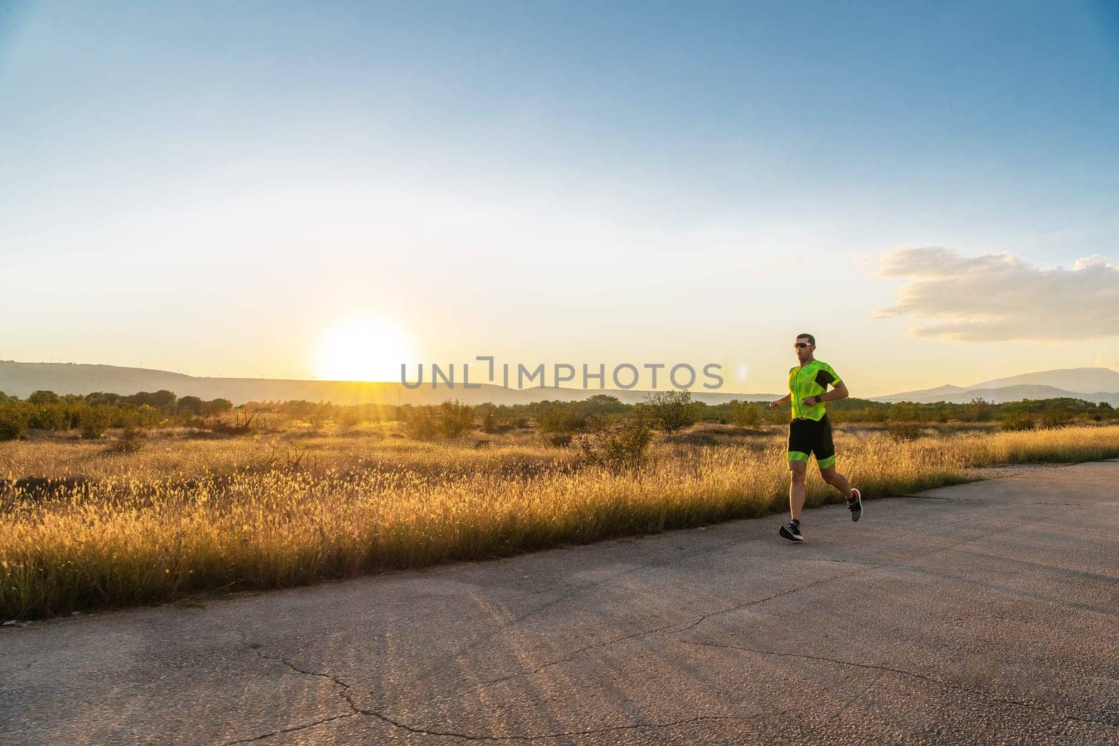 Triathlete in professional gear running early in the morning, preparing for a marathon, dedication to sport and readiness to take on the challenges of a marathon