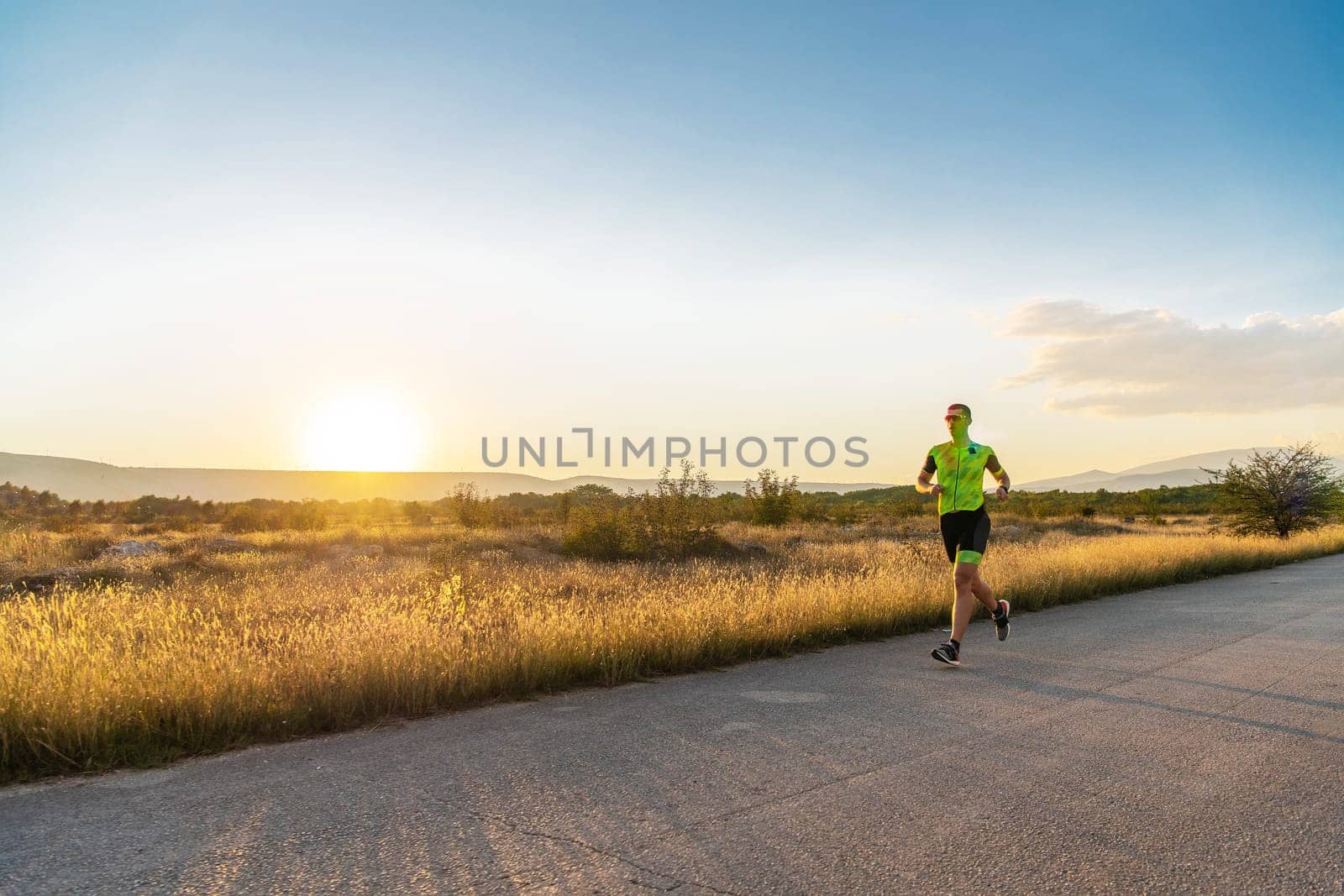 Triathlete in professional gear running early in the morning, preparing for a marathon, dedication to sport and readiness to take on the challenges of a marathon