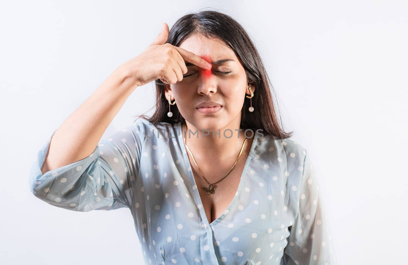 Person with nasal bridge pain, Girl with nasal bridge headache. Sinus pain concept. Young woman with pain touching nose