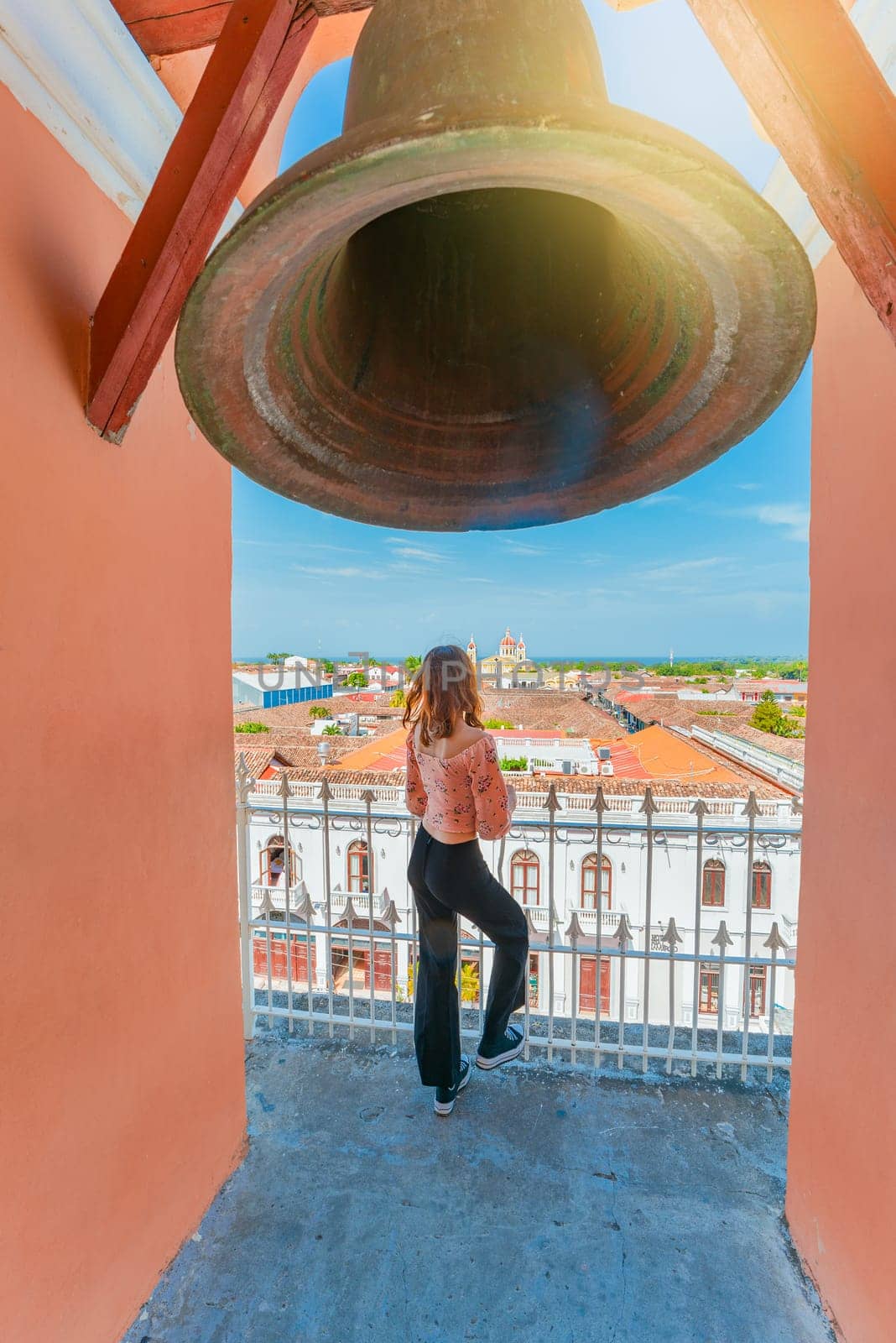 Tourist girl at the viewpoint of the La Merced church with a panoramic view of the Granada cathedral