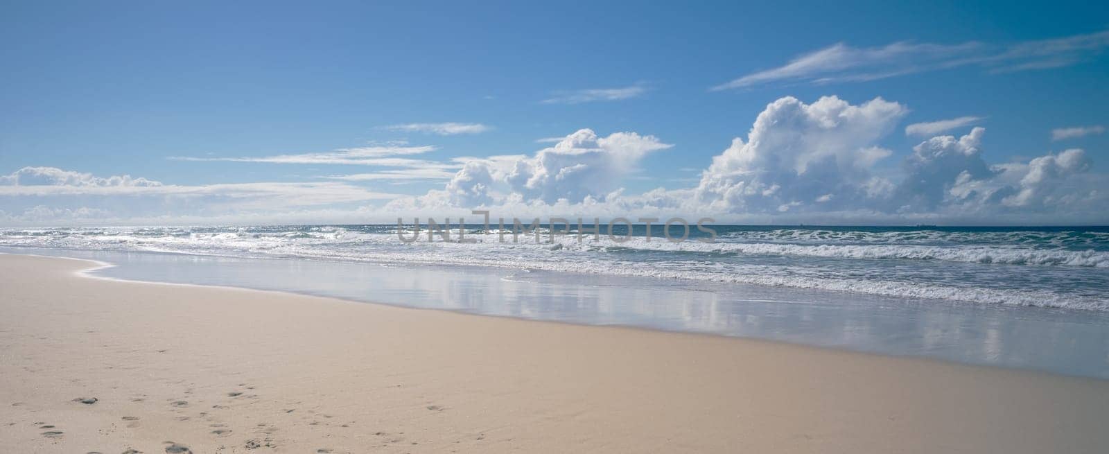 A sunny day beach scene in panorama view seascape landscape