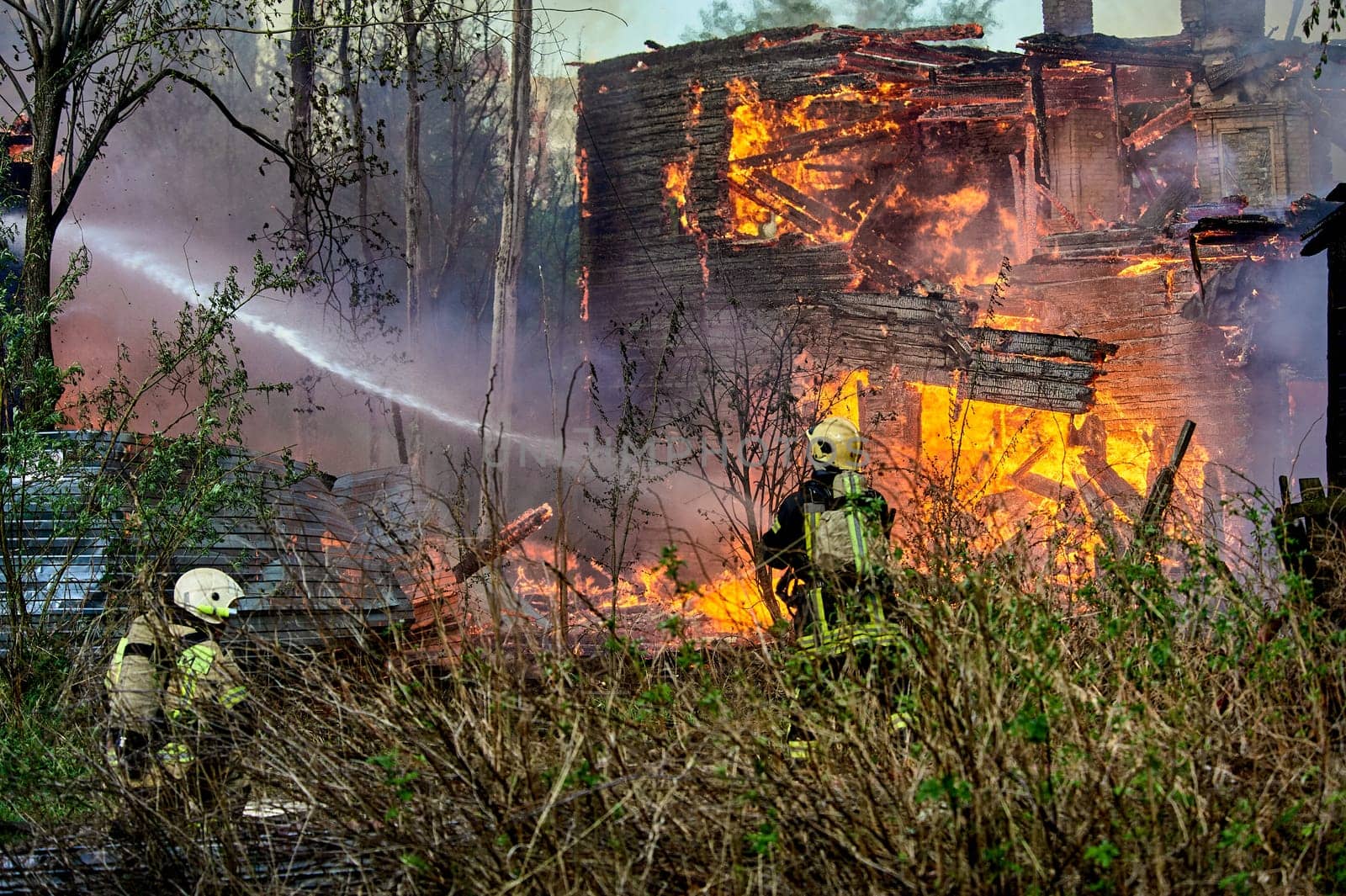 extinguishing the fire of a wooden house. High quality photo