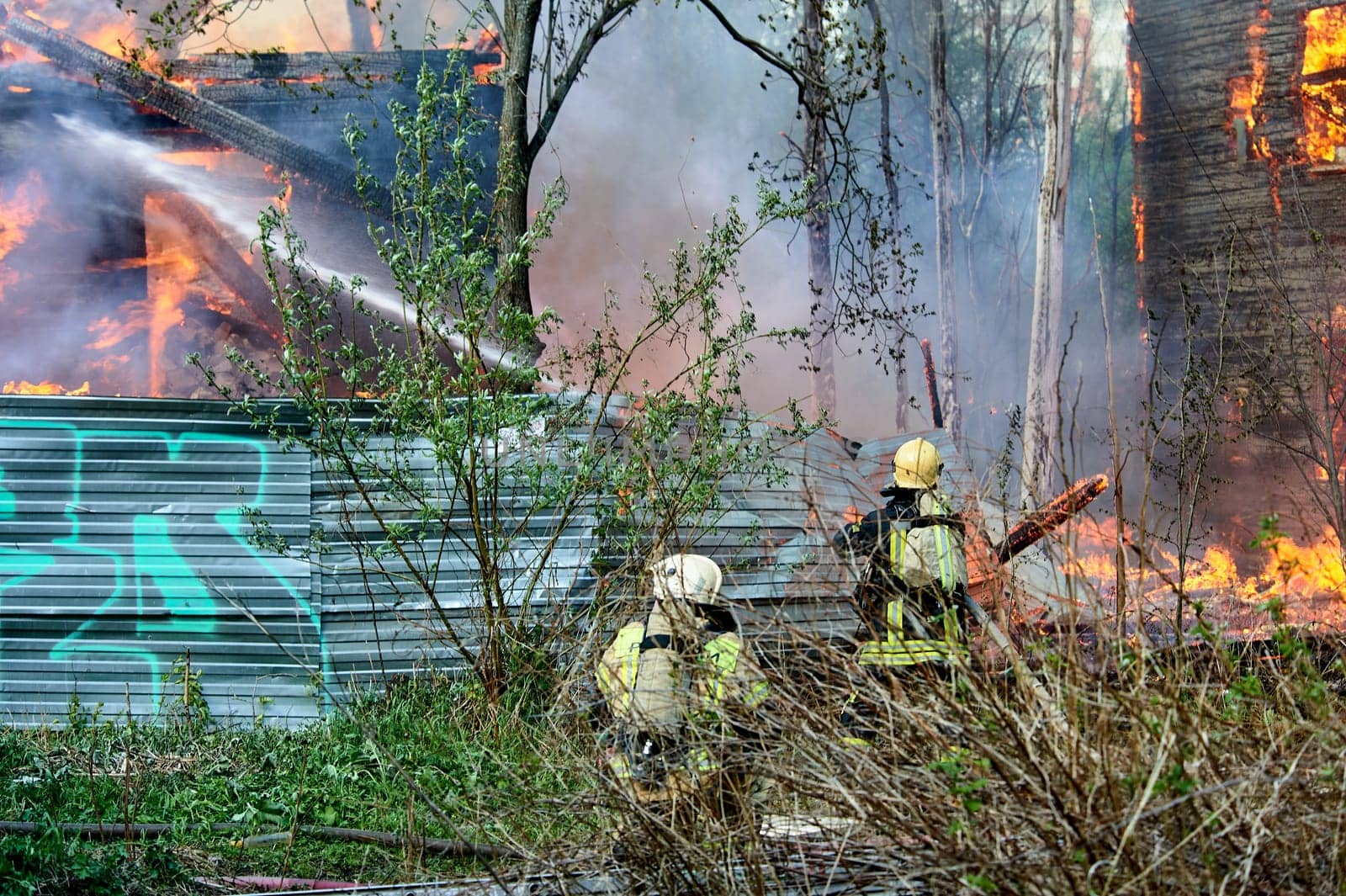 extinguishing the fire of a wooden house. High quality photo
