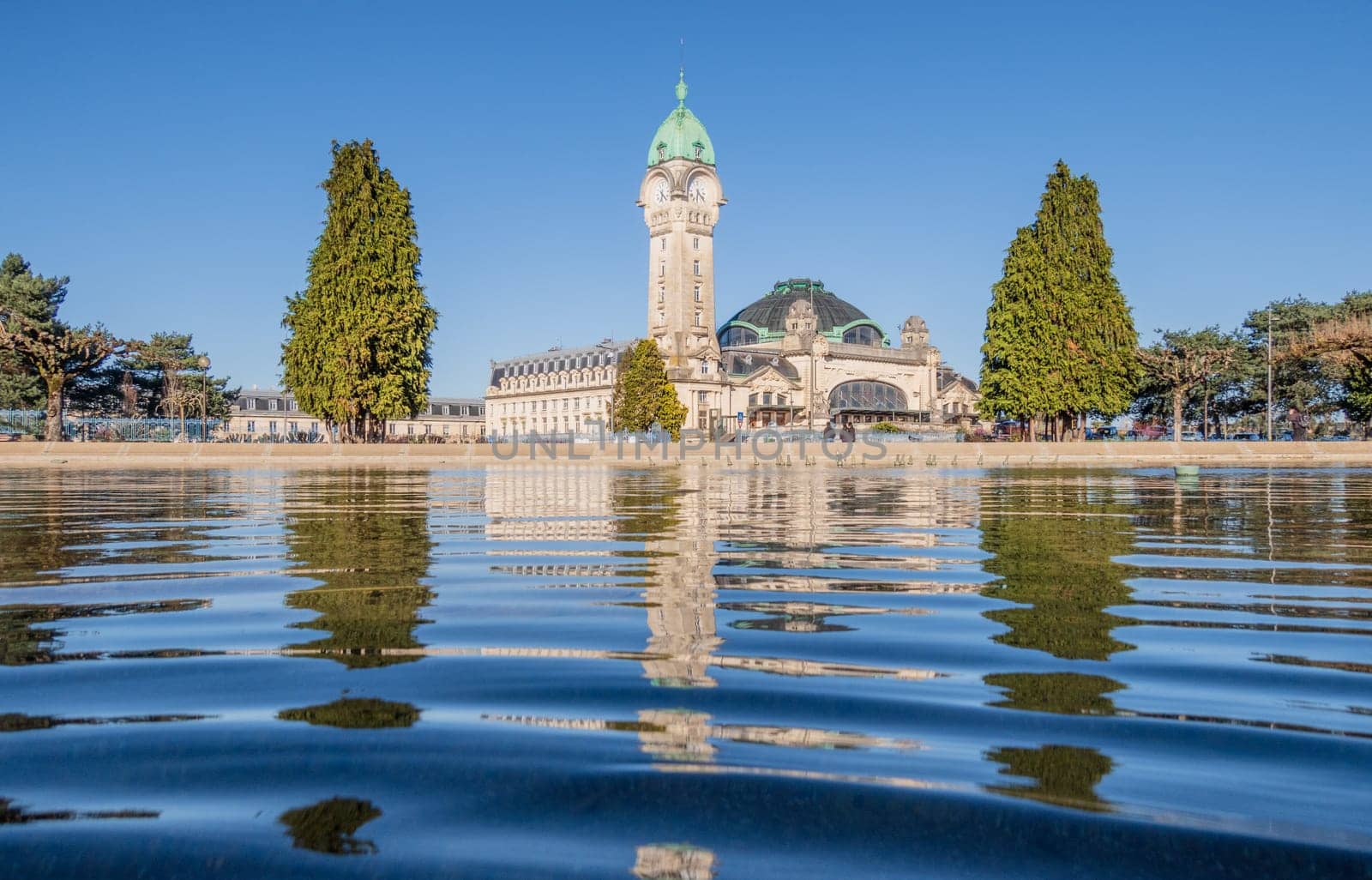 Limoges, France - April 04 2023: View of the famous Limoges train station called Limoges-Bénédictins reflecting in water, in France