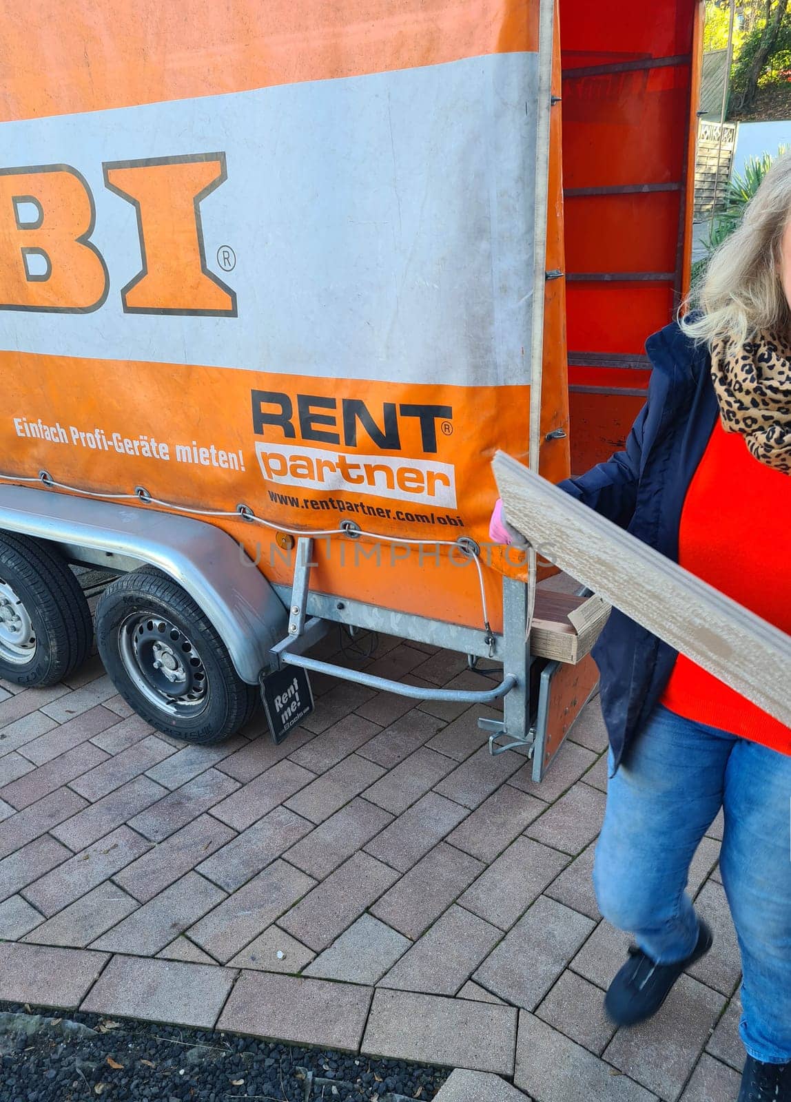 HEILIGENHAUS, NRW, GERMANY - NOVEMBER 06, 2020: Heiligenhaus, Nrw, Germany - November 06, 2020: Off-road vehicle with trailer with tarpaulin from the DIY chain from Germany Obi