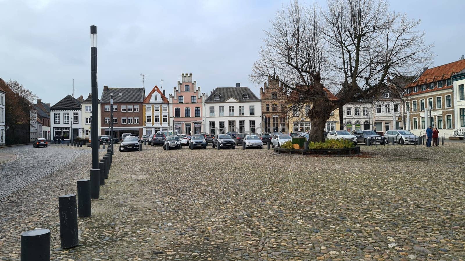KALKAR NRW, GERMANY - NOVEMBER 14, 2021: Kalkar, Nrw, Germany - November 14, 2021:  Trees and houses in the city against the sky in autumn