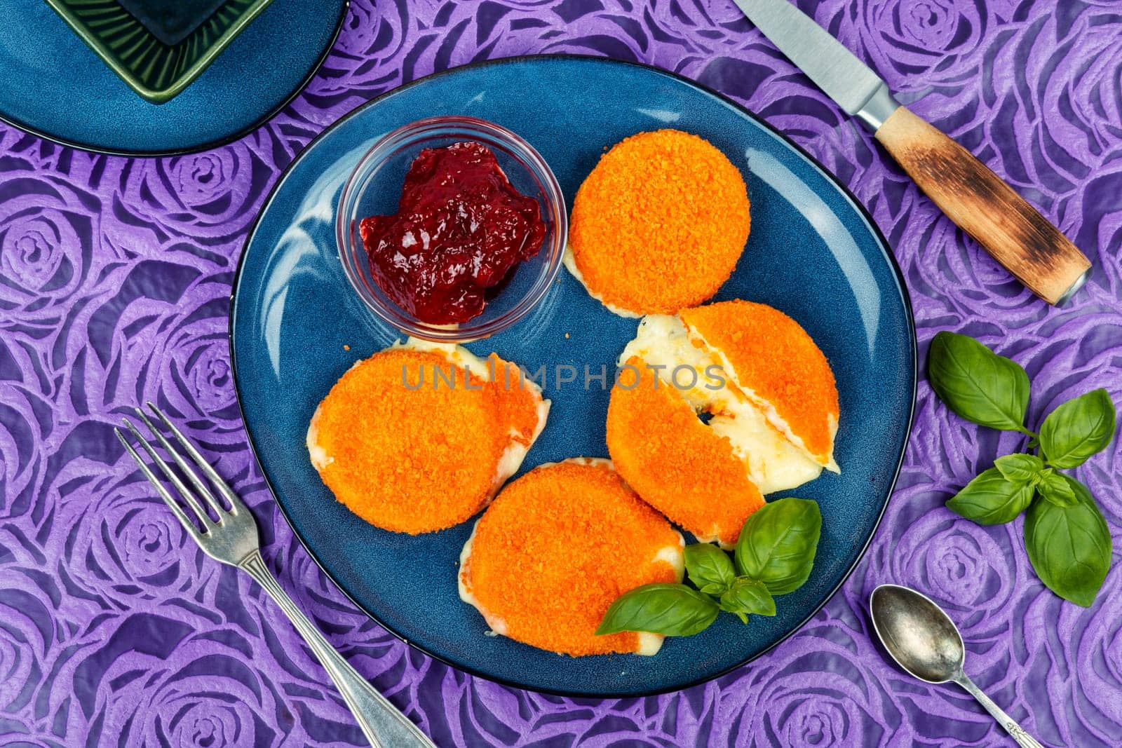 Baked and melted camembert cheese with berry sauce