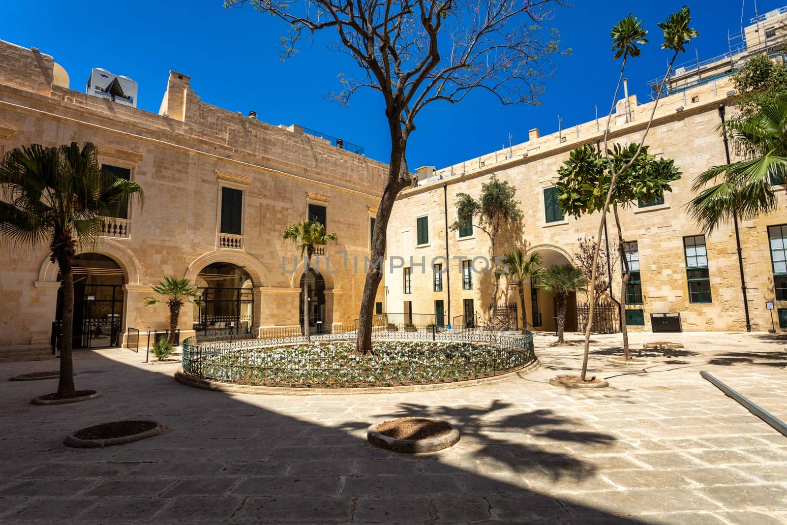 Historic Grandmaster's Palace courtyard with impressive architectural details and traditional Maltese stonework in Valletta. Cultural heritage of Malta